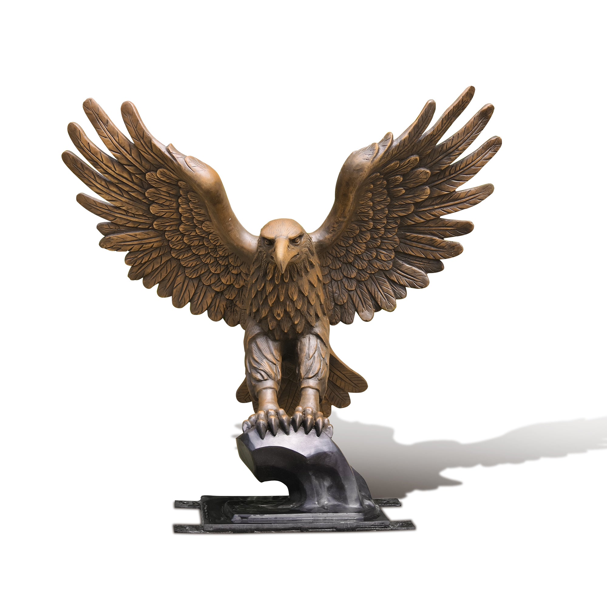 Bronze statue of an eagle with outstretched wings on a white background