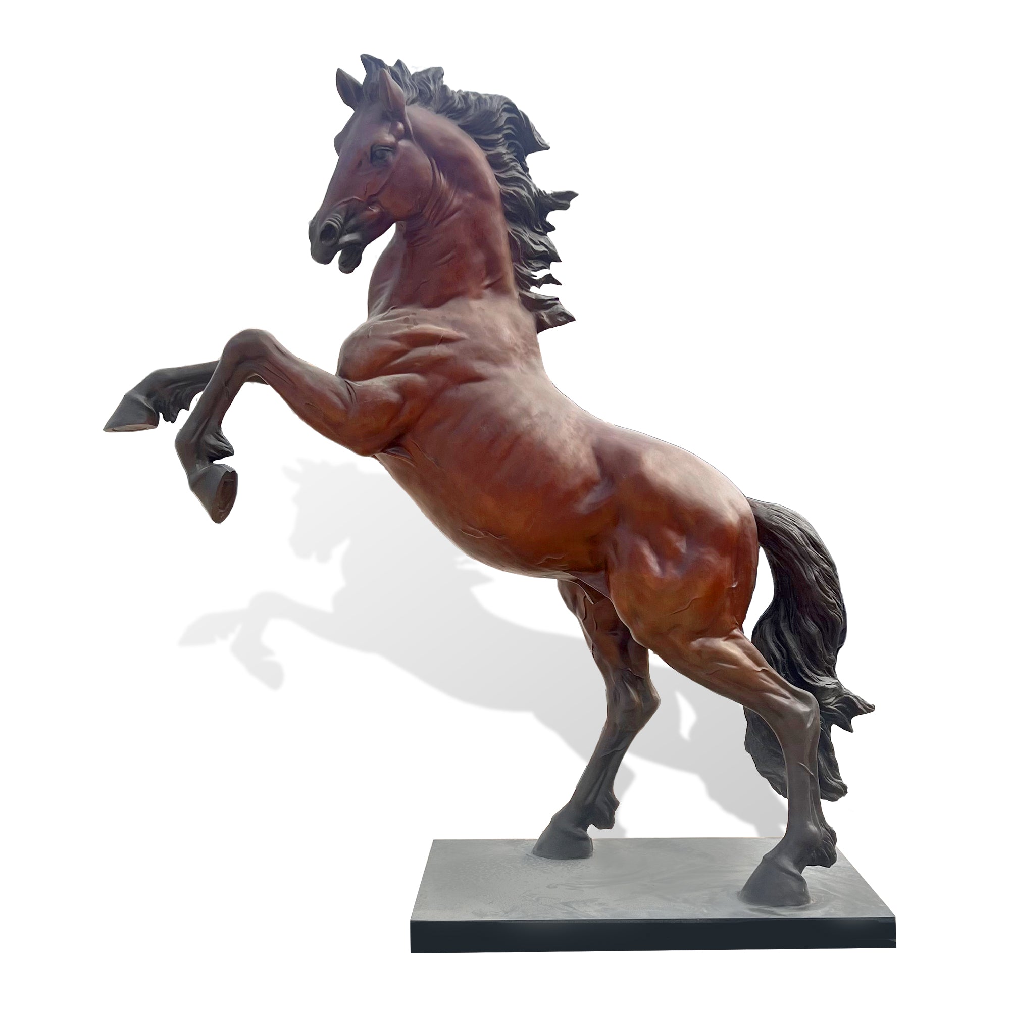 A polished bronze prancing horse sculpture on a pedestal