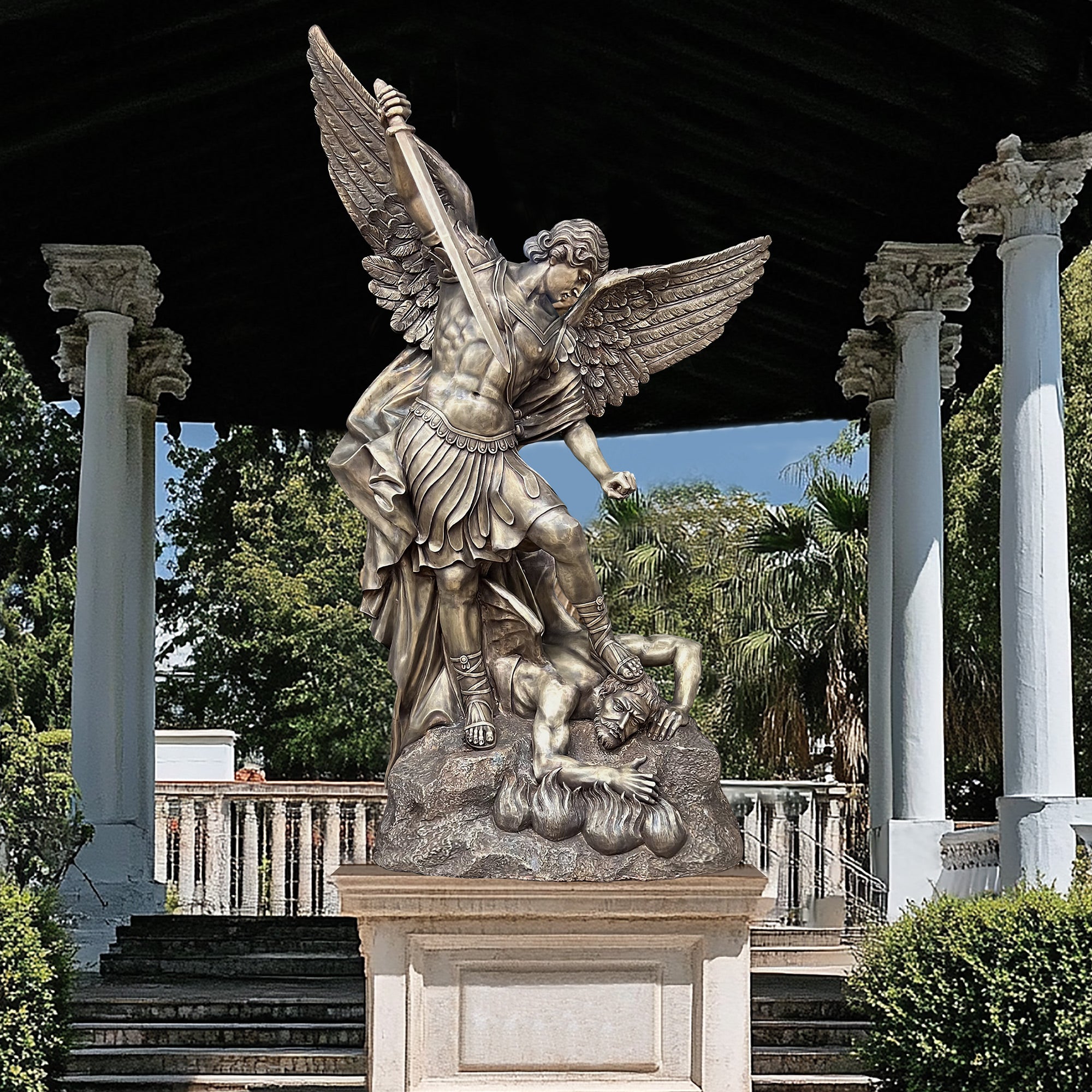 St. Michael the Archangel defender bronze statue with antique bronze finish, display above a pedestal.