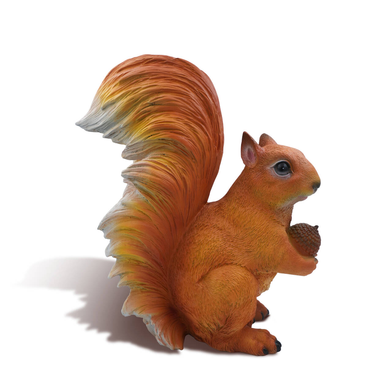 White background image of bronze squirrel statue holding an acorn, side view