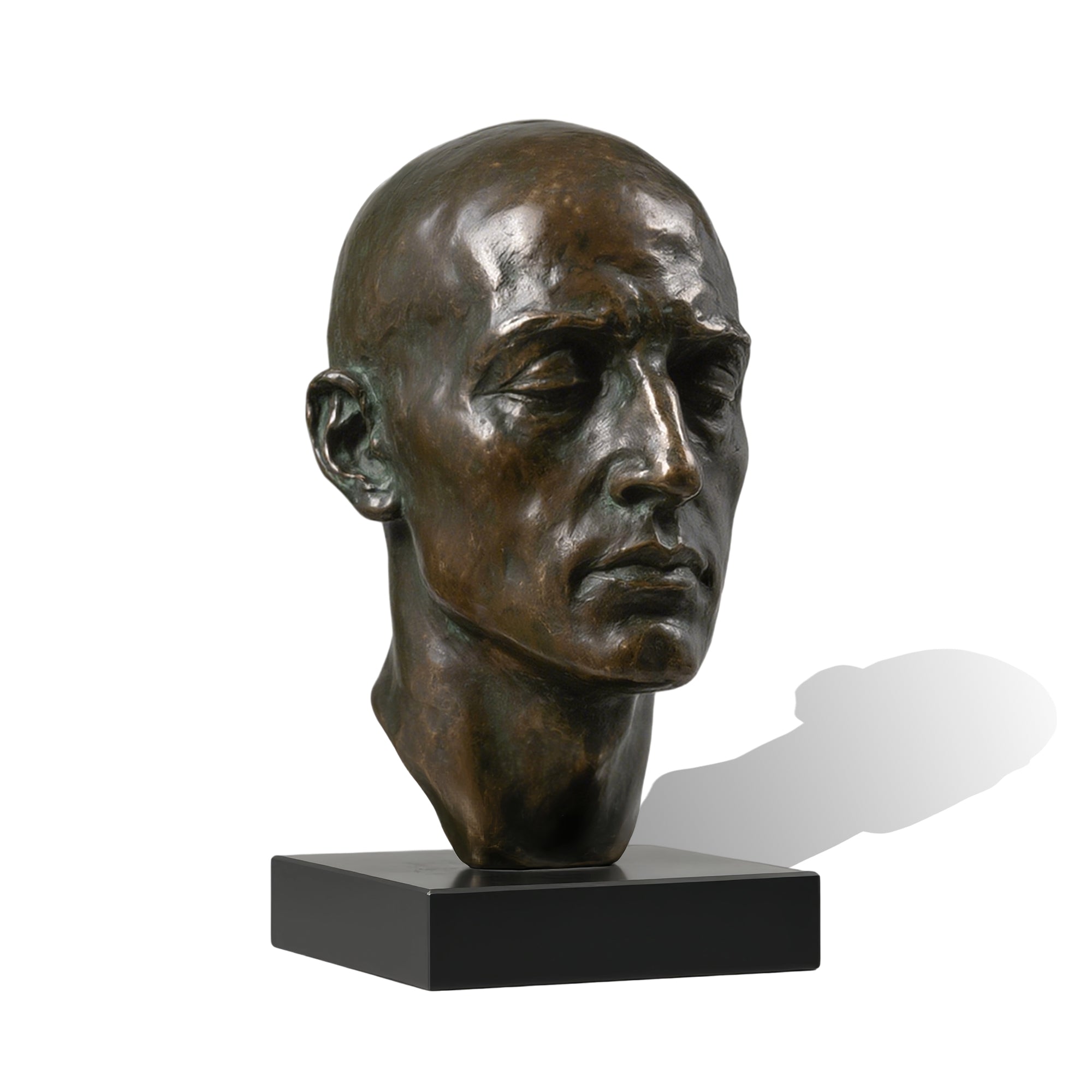 Bronze bust of a man's head on a white background