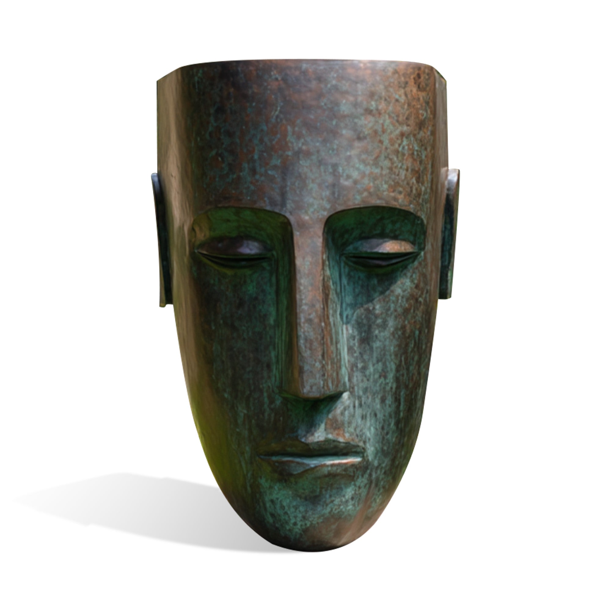 Bronze mask with a textured surface on a white background