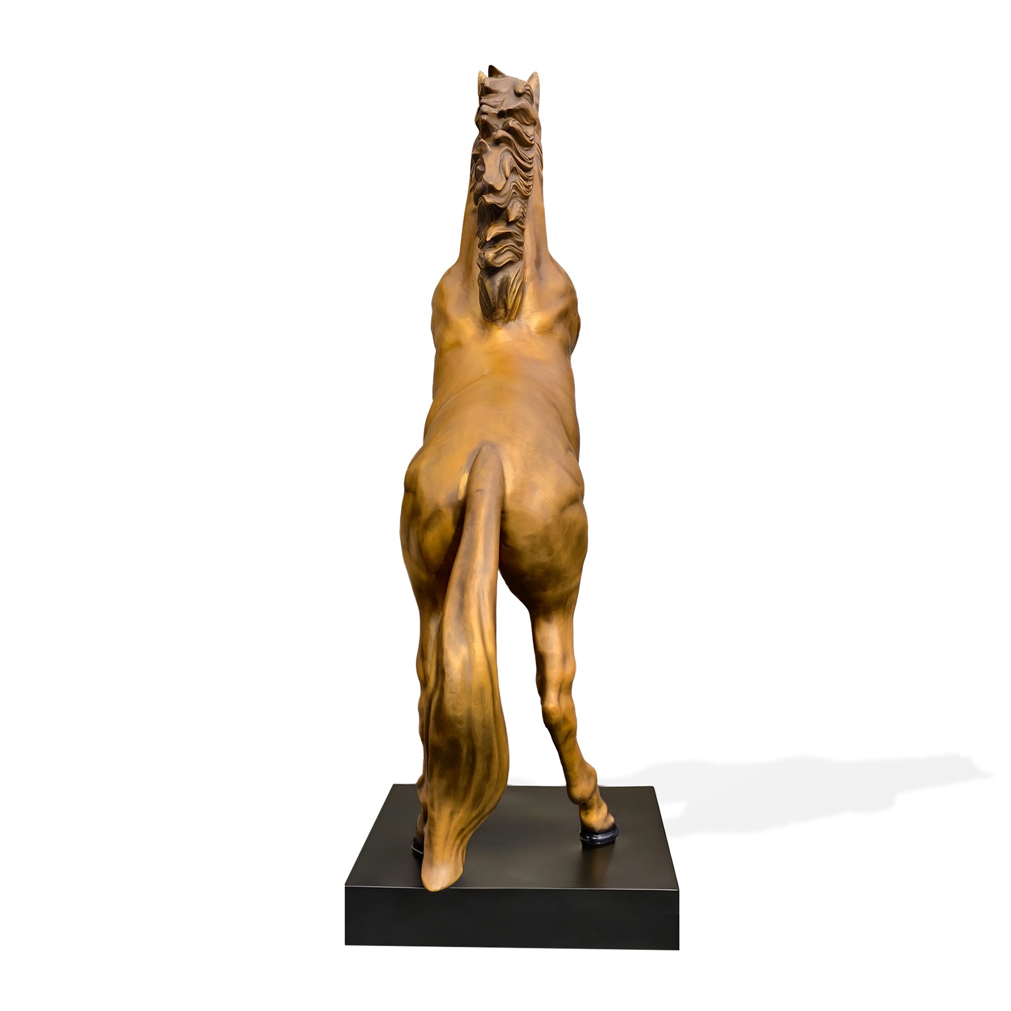 Rear view of a golden bronze Chinese zodiac horse sculpture standing on a black base with raised front legs, flowing tail, sculpted mane, and muscular hind legs.