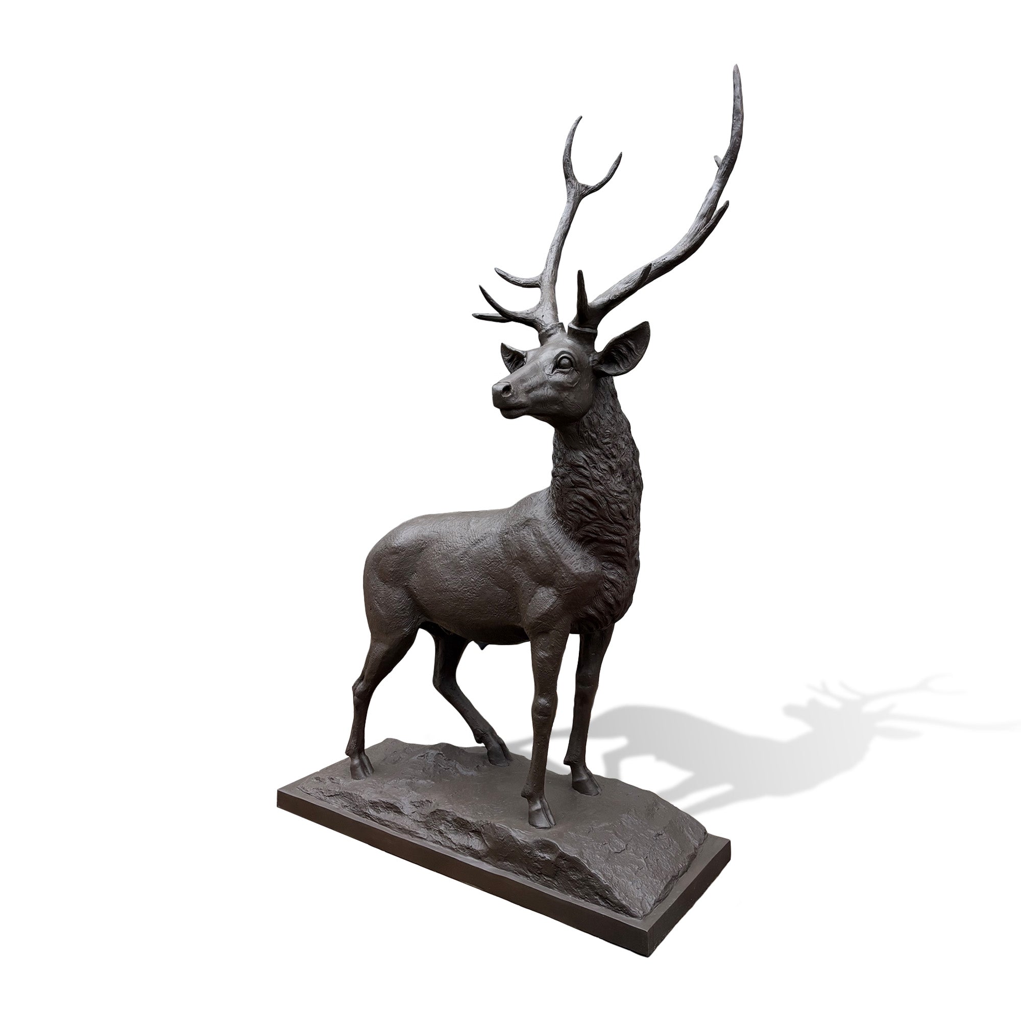 Side view of bronze elk sculpture with detailed antlers, textured body, and natural standing posture on a rocky base