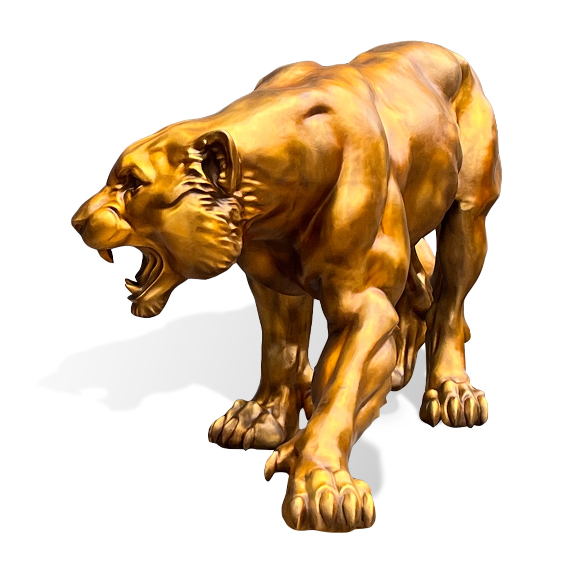 Front three-quarter view of a golden bronze zodiac tiger statue with an open roaring mouth, extended front paw, muscular shoulders, sharp claws, and dynamic stalking posture on a white background.