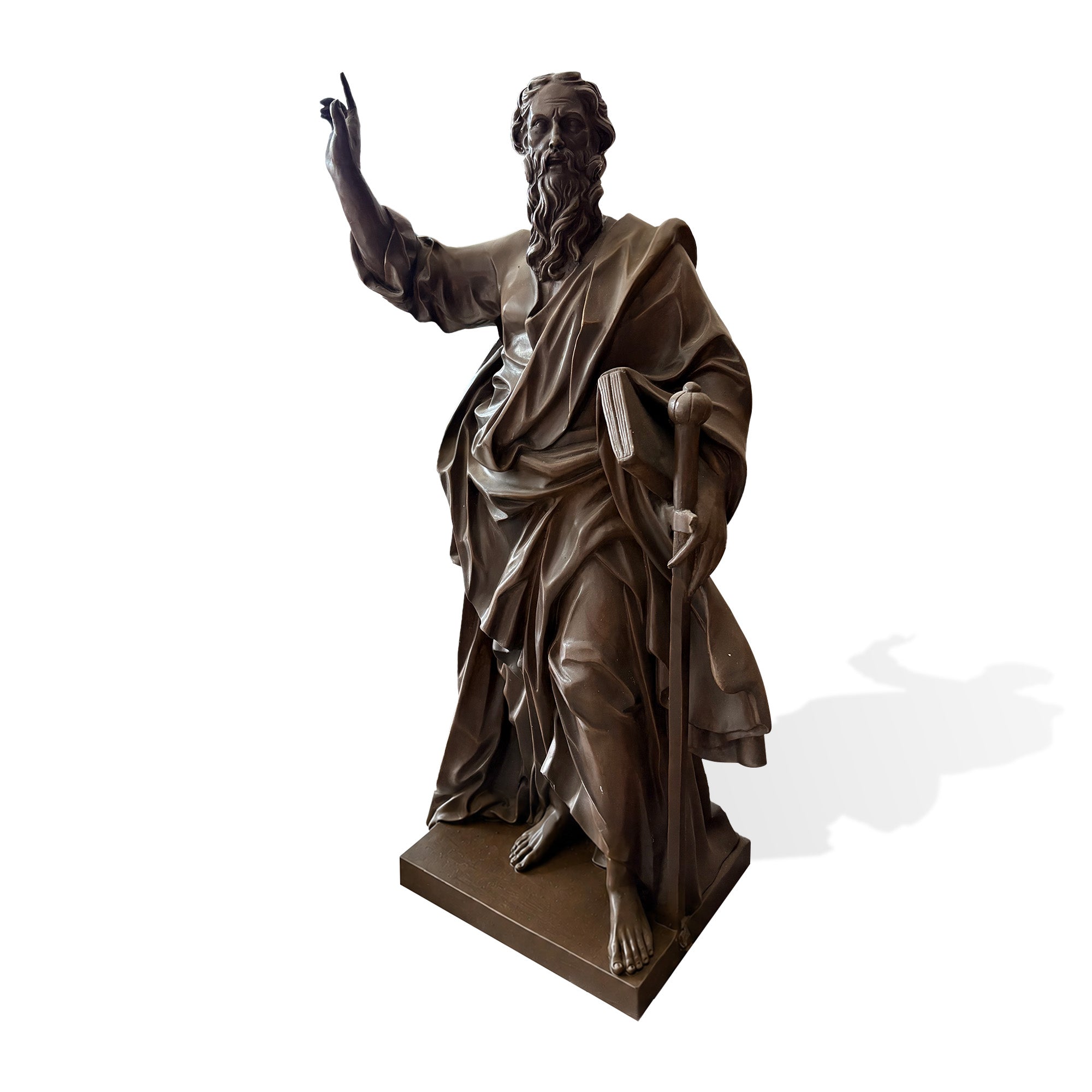 Front three-quarter view of a bronze Saint Paul religious statue with raised blessing hand, long beard, draped robe, book, sword, and rectangular base on a light background.