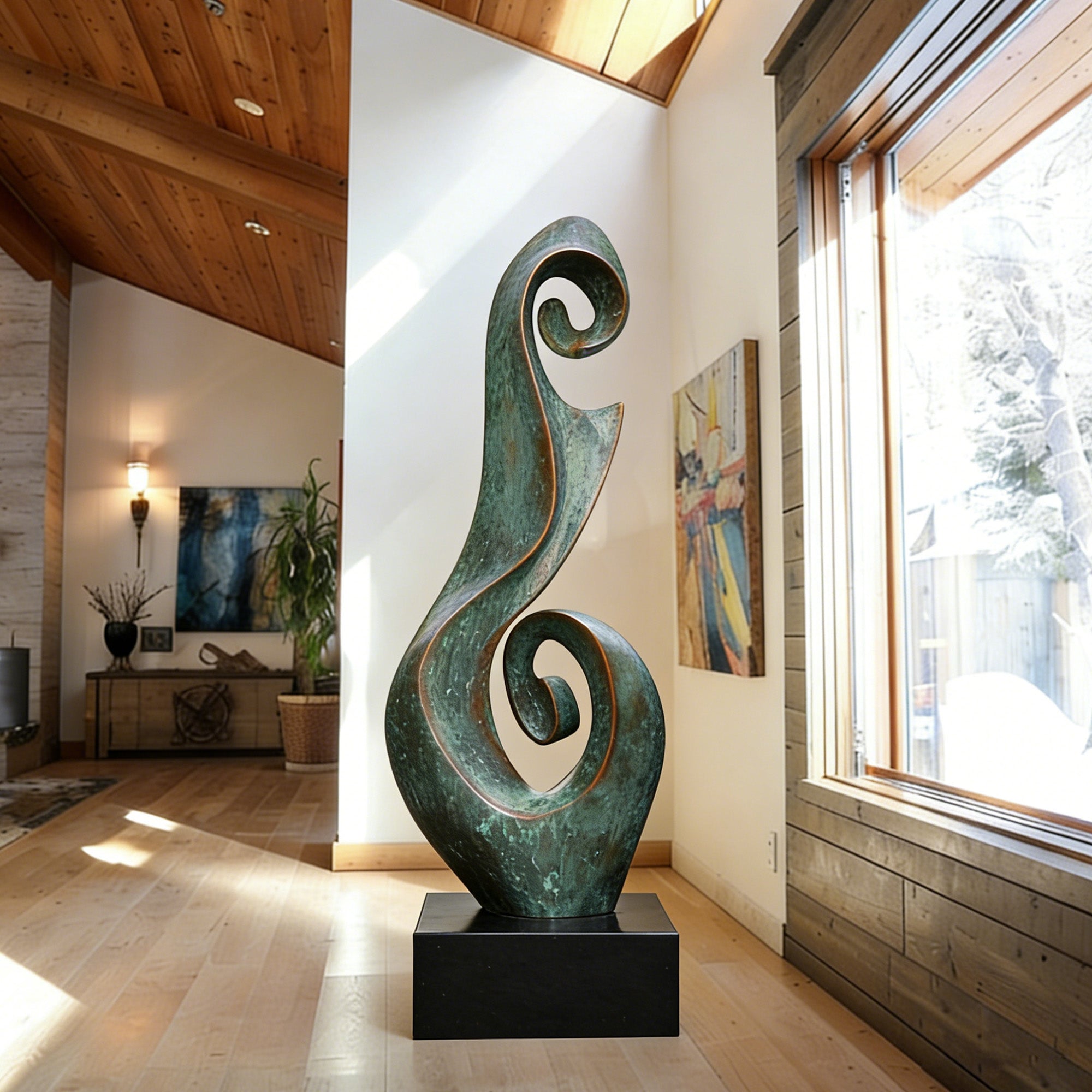Verdigris bronze spiral sculpture placed on a black pedestal inside a bright modern interior with wood ceiling, large window, curling vertical design, and aged green patina.