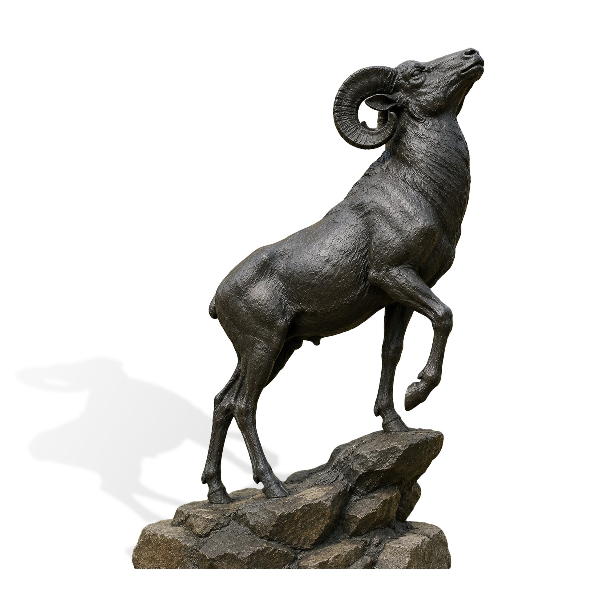 Bronze bighorn ram sculpture with curled horns standing on a rugged rock base, handcrafted wildlife statue for gardens, ranches, estates, and commercial landscapes.