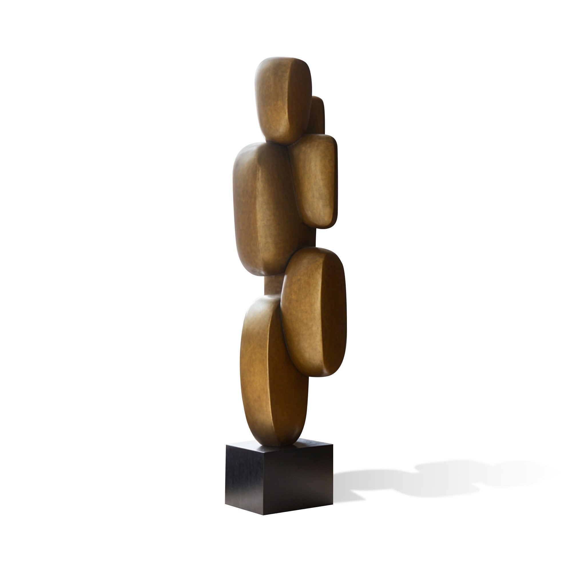 Abstract stacked bronze sculpture with rounded geometric forms, vertical balancing composition, warm patina finish, and black display base on white background