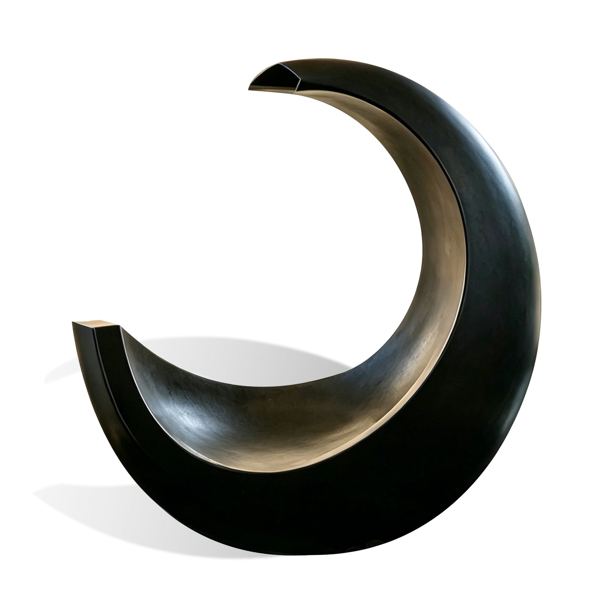 Bronze crescent fountain sculpture with curved water channel, dark bronze finish, pebble basin, and compact base on white background