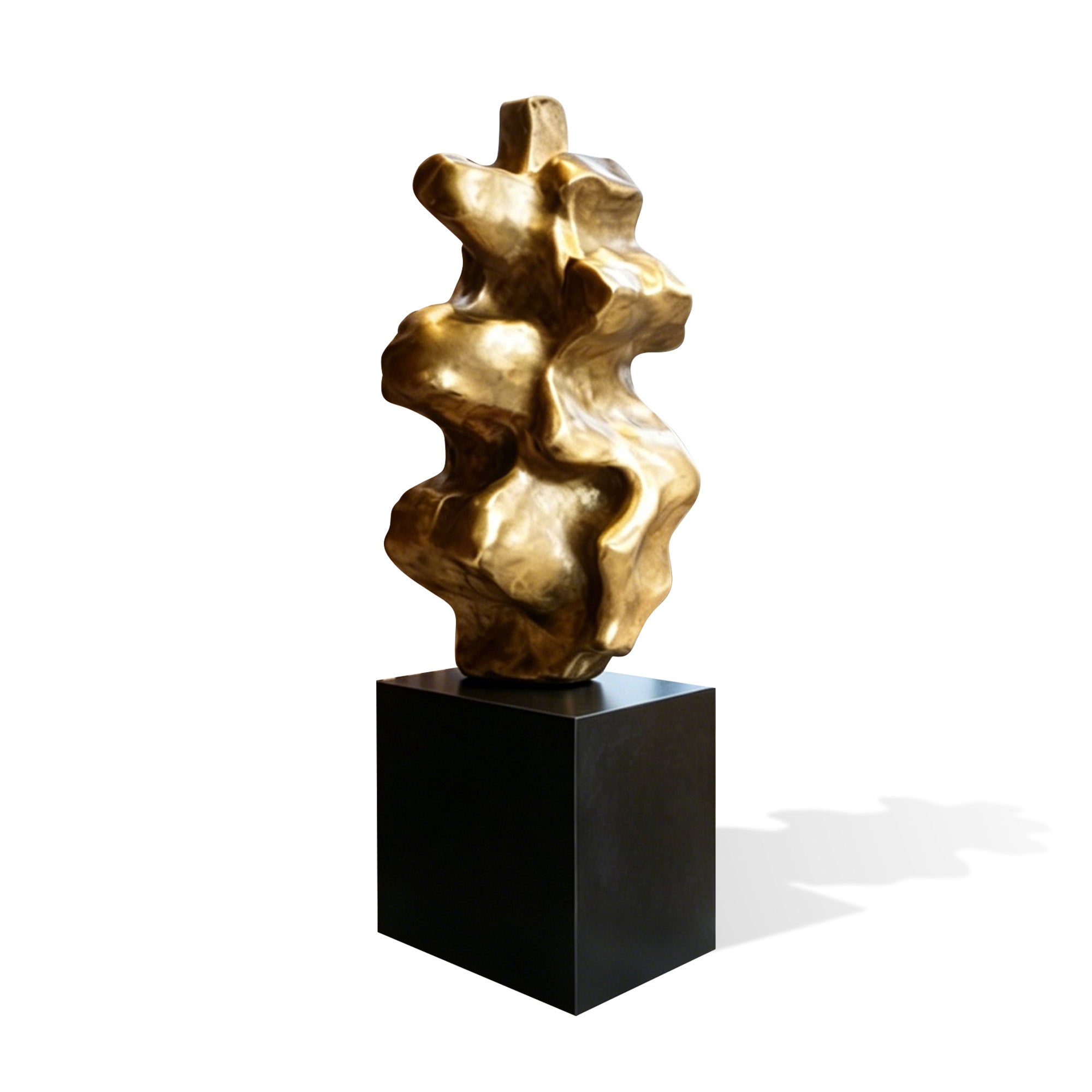 Gold modern abstract sculpture featuring a unique organic shape, smooth curved surfaces, and a polished metallic finish displayed on a minimalist black pedestal.
