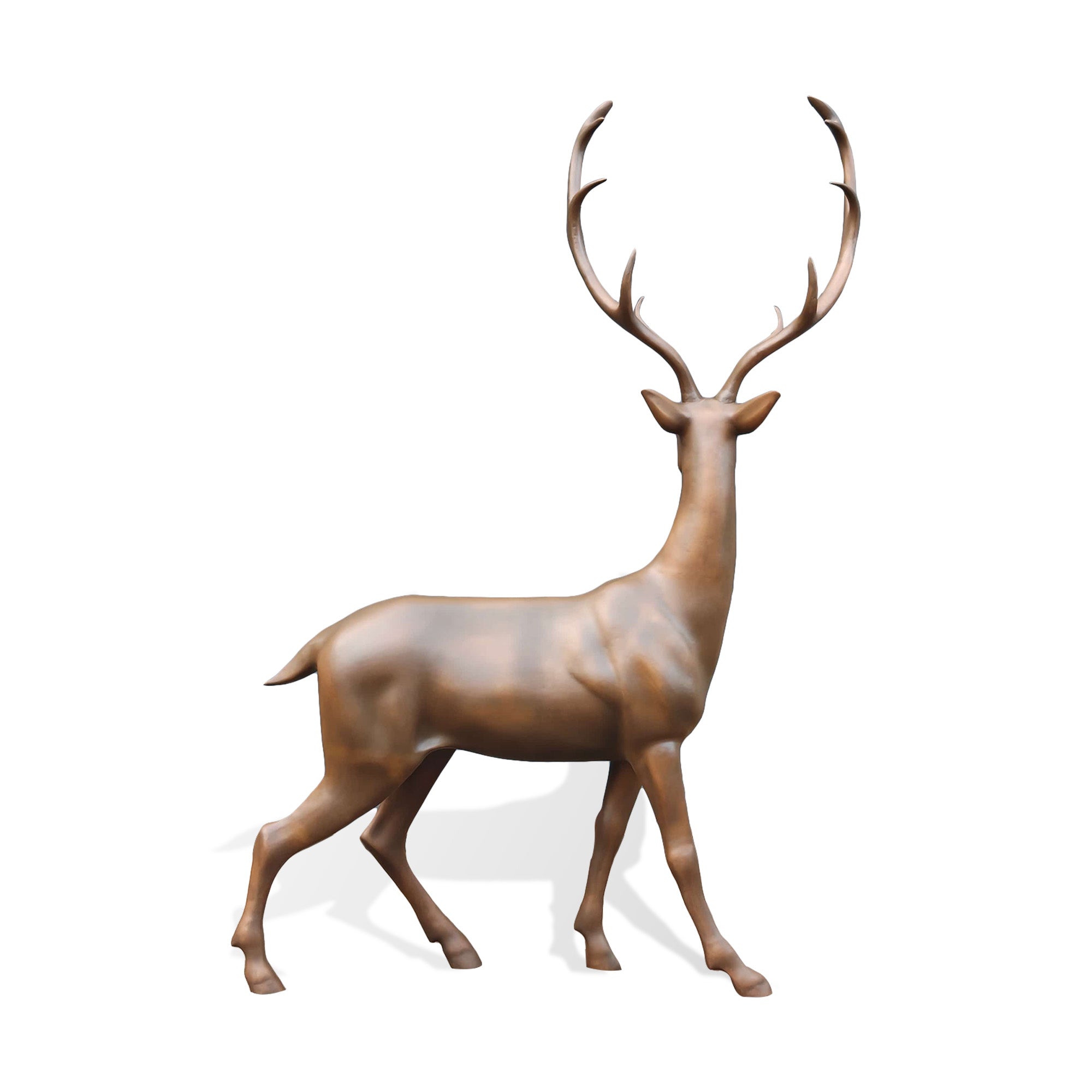 Rear view of an outdoor bronze stag sculpture showing the smooth sculpted body, raised antlers, natural leg movement, and refined warm brown bronze finish.