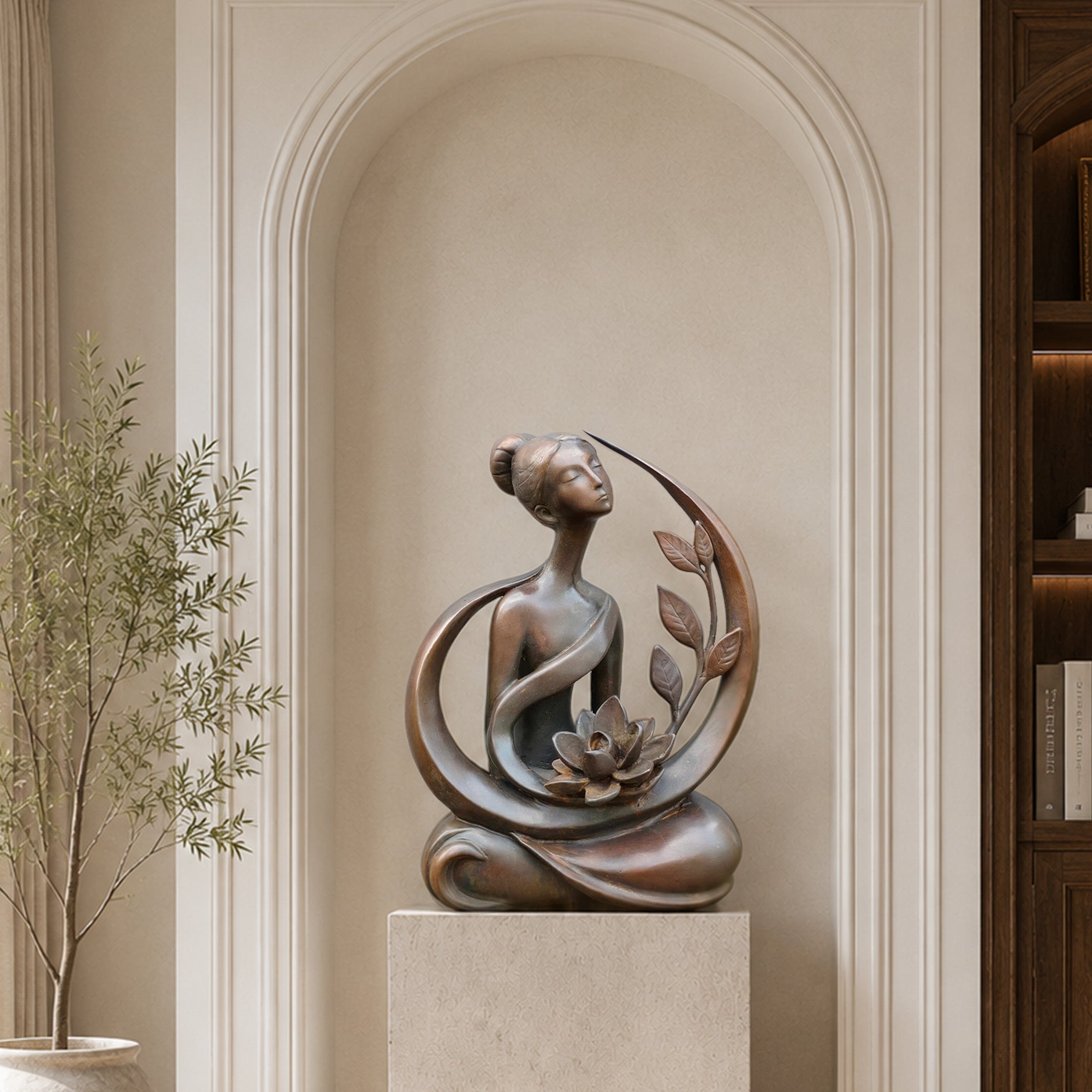 Bronze female lotus sculpture displayed on a pedestal in an elegant interior, featuring a meditative woman, sweeping curves, botanical leaves, and lotus flower details.
