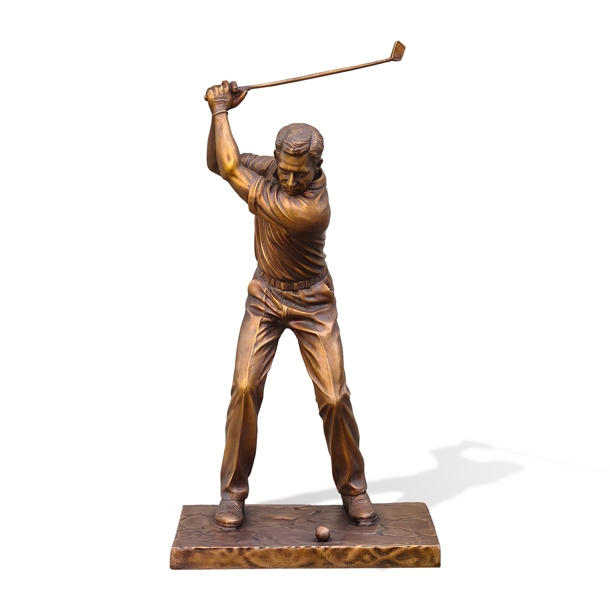 Bronze golfer statue shown on a white background, featuring a male golfer captured at the top of his backswing with both hands gripping a raised golf club, realistic clothing folds, golf shoes, ball, textured rectangular base, and warm antique bronze finish.