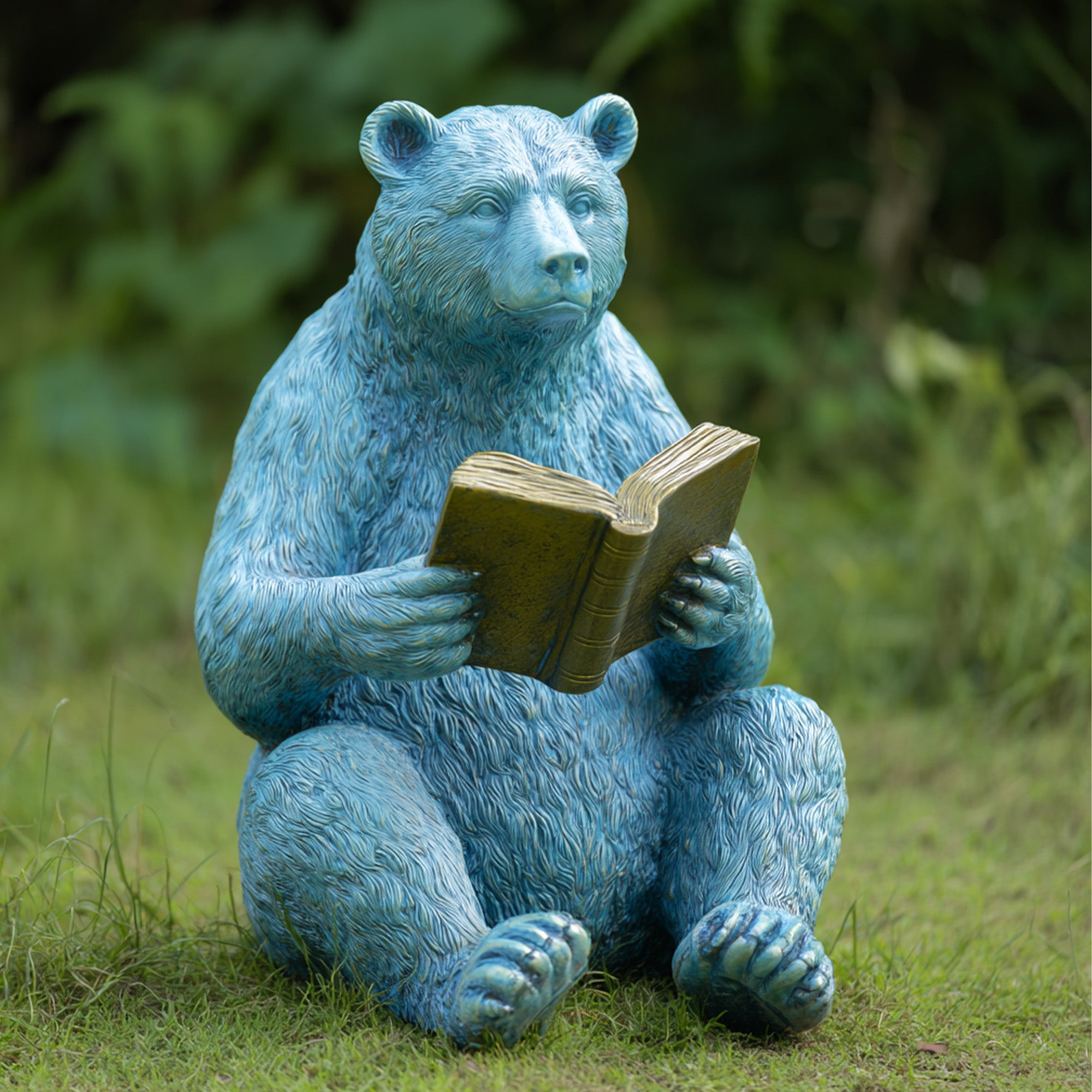 storytime reading blue bear garden sculpture holding a book, outdoor decorative animal statue on grass