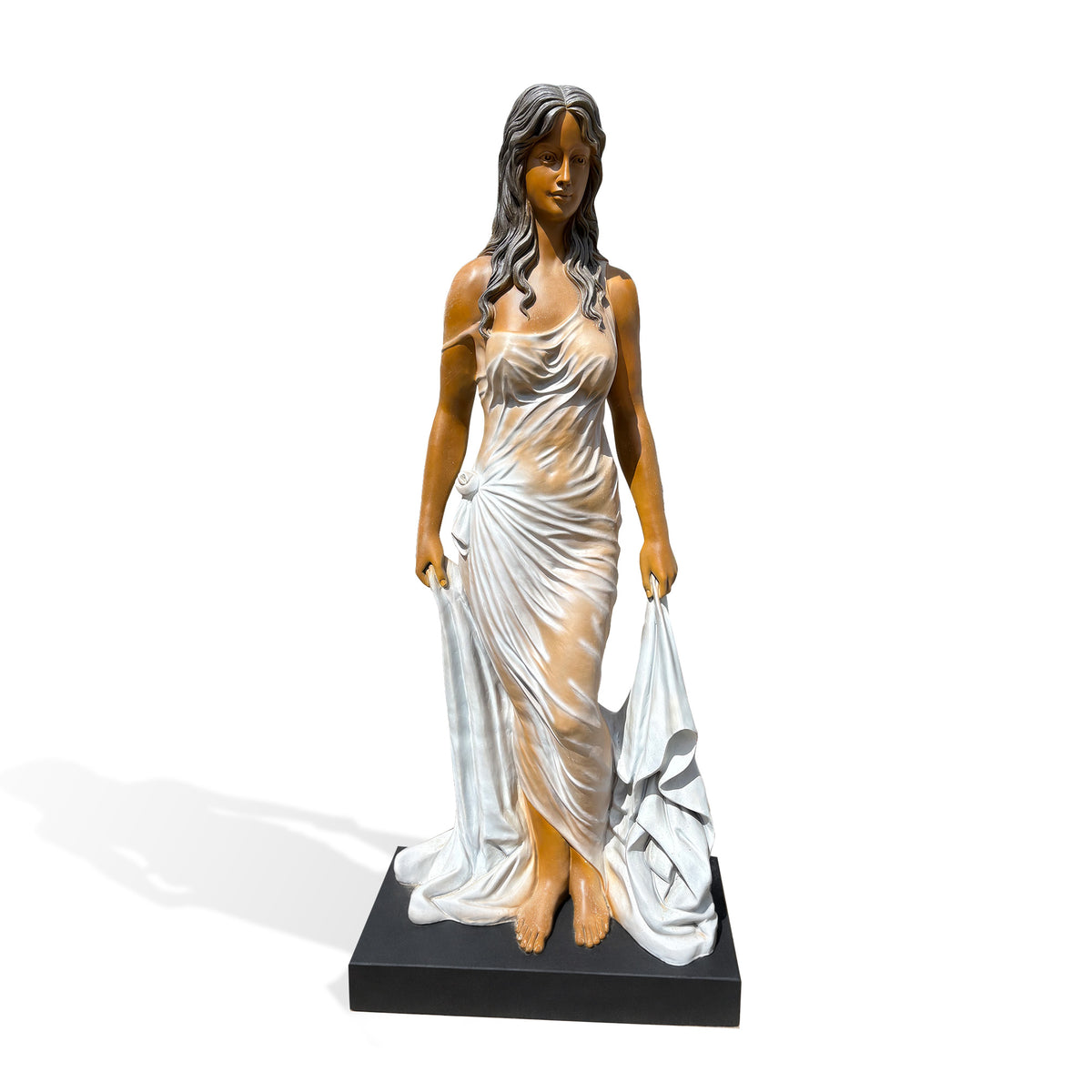 Front view of a fiberglass woman statue with center-parted dark waves, a softly modeled face and a floor-length draped gown. A rose-shaped detail gathers the fabric at her hip, while her hands lift long side panels that pool around her bare feet on a black base.