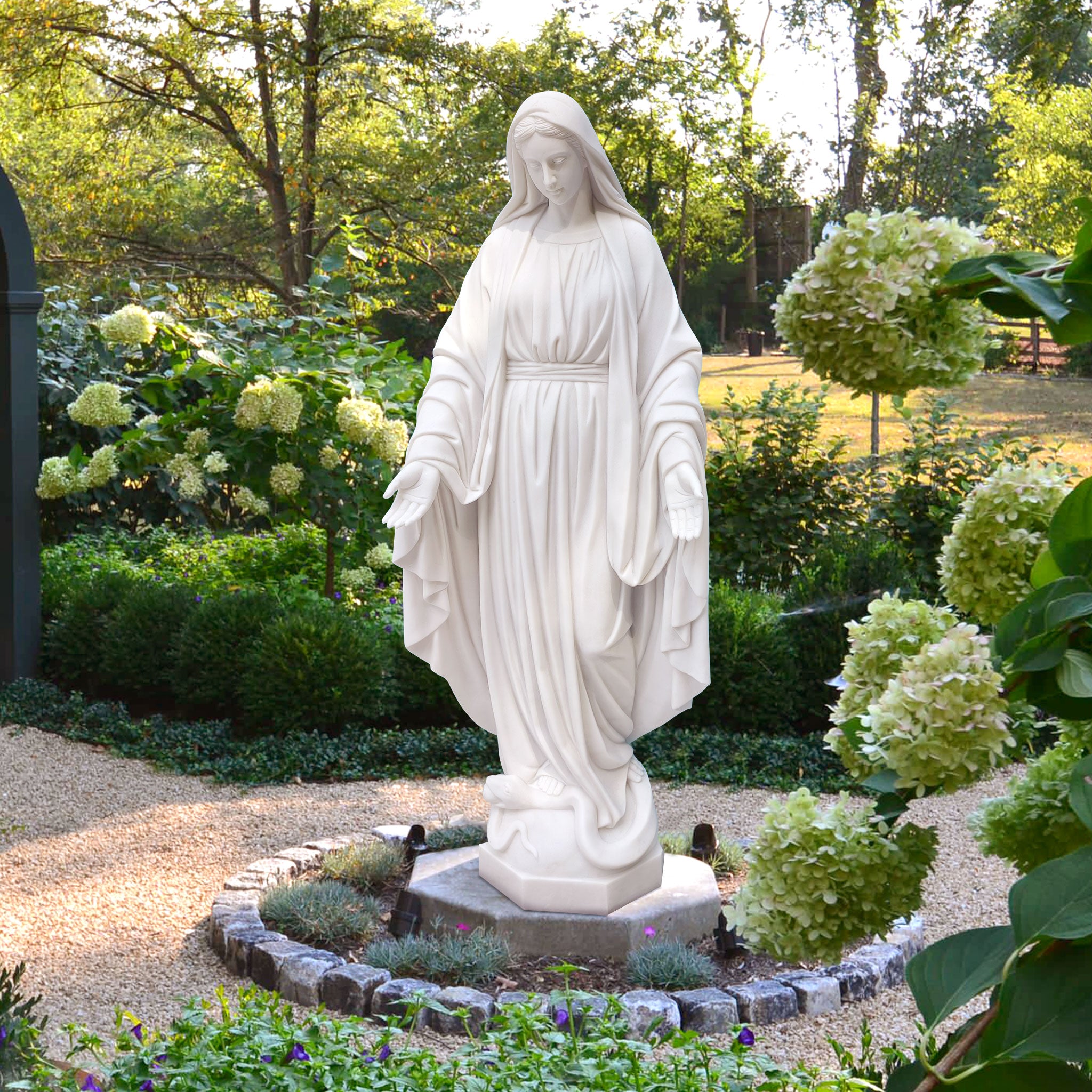 Immaculate Conception Virgin Mary Statue placing in a garden