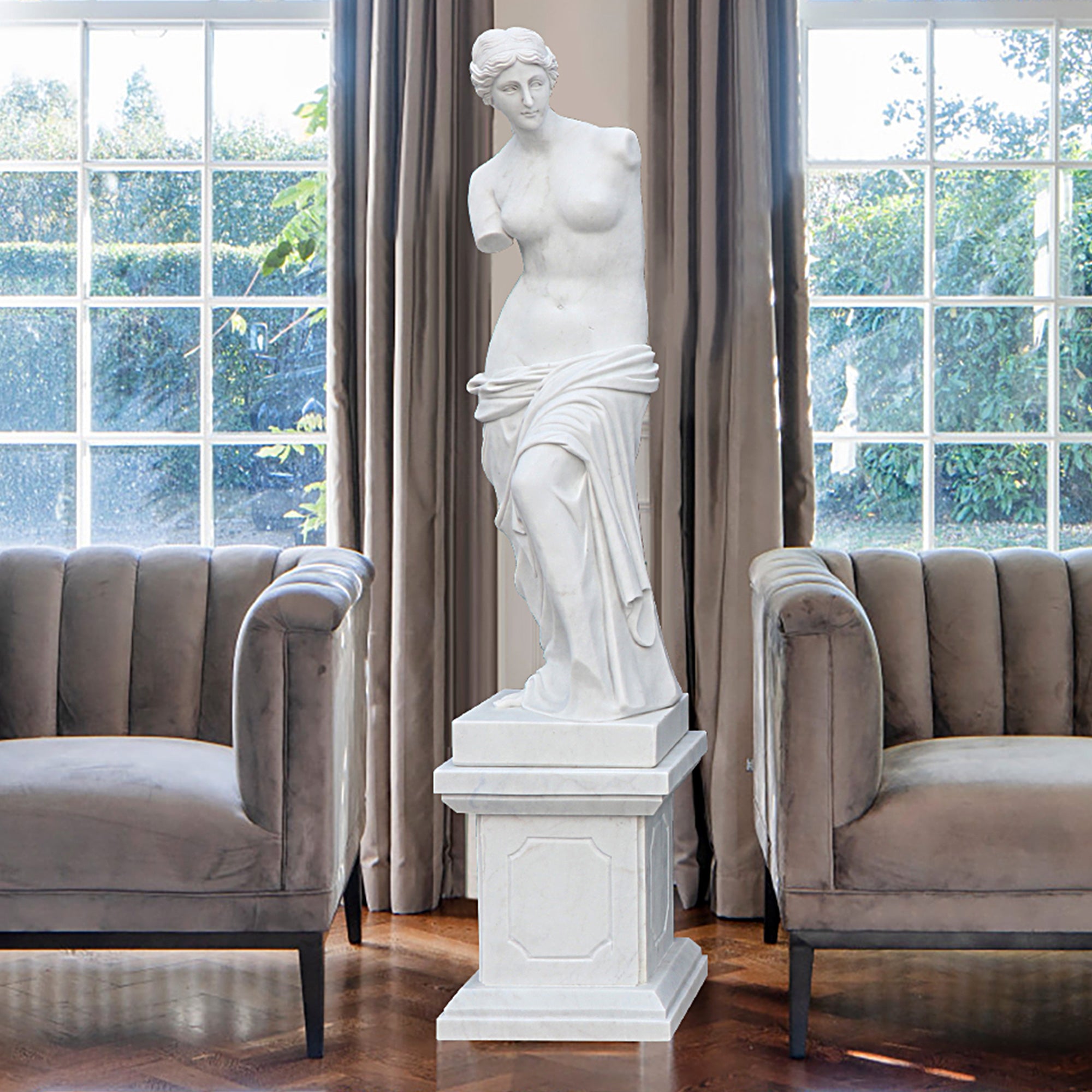 White marble Venus de Milo replica statue on a square pedestal, featuring classical drapery and elegant form display luxury indoor