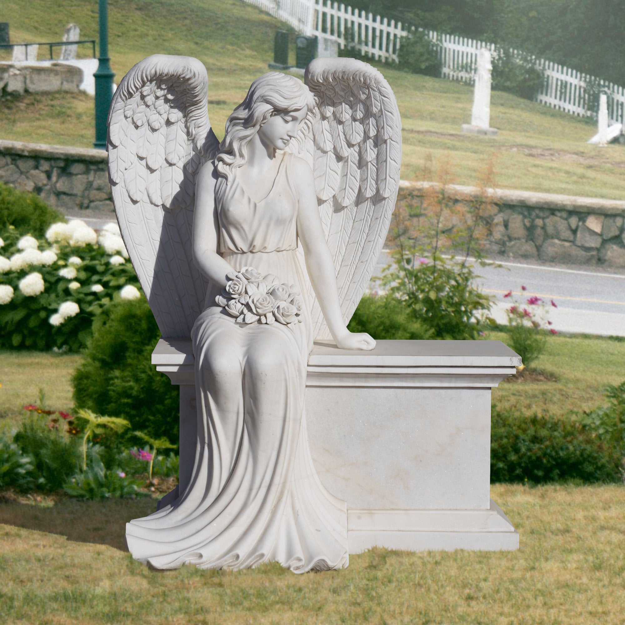 Stone angel statue seated on a bench holding roses, set in a peaceful garden environment.