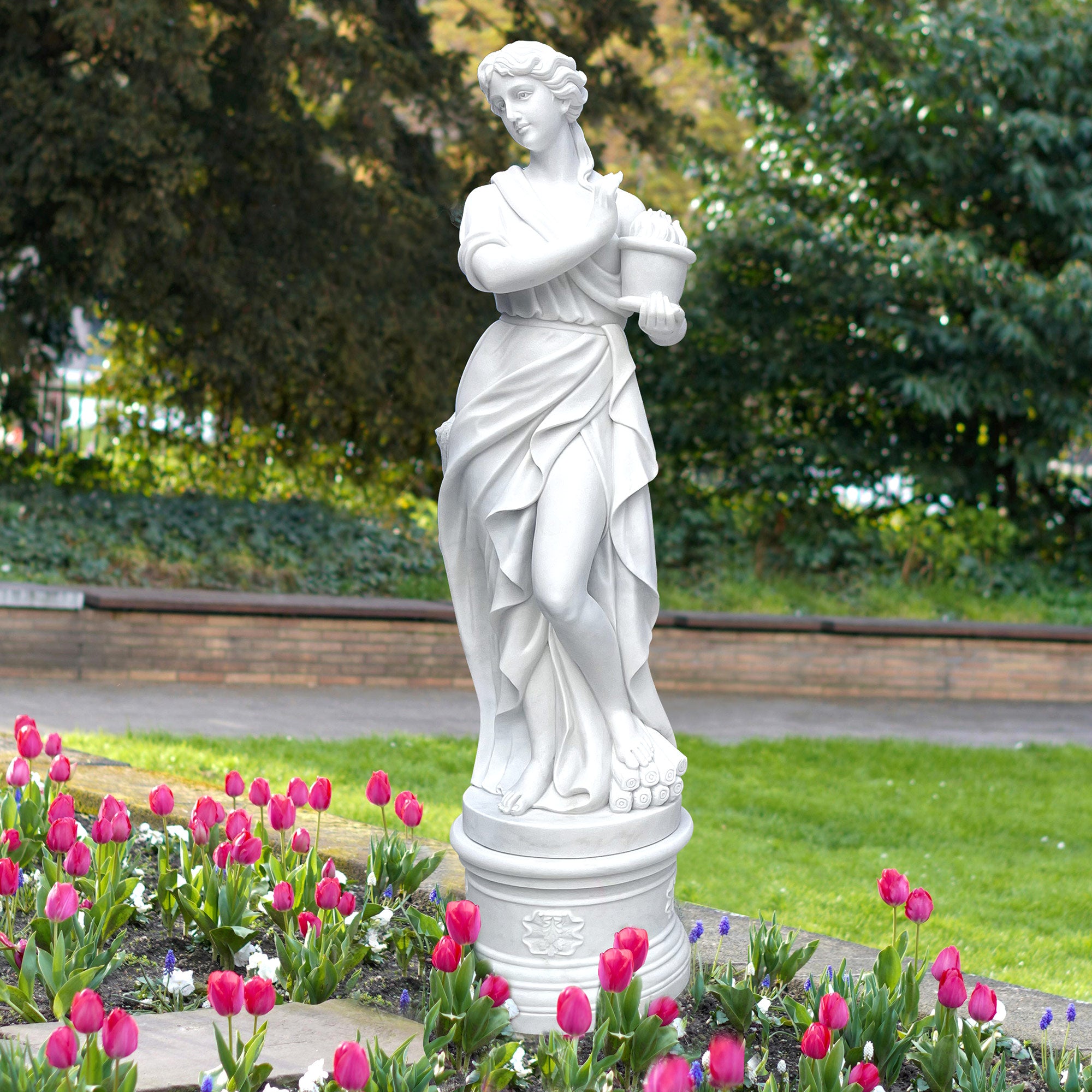 Hand-carved statuary marble Greek Winter Goddess statue from "The Four Seasons" collection, display in outdoor garden