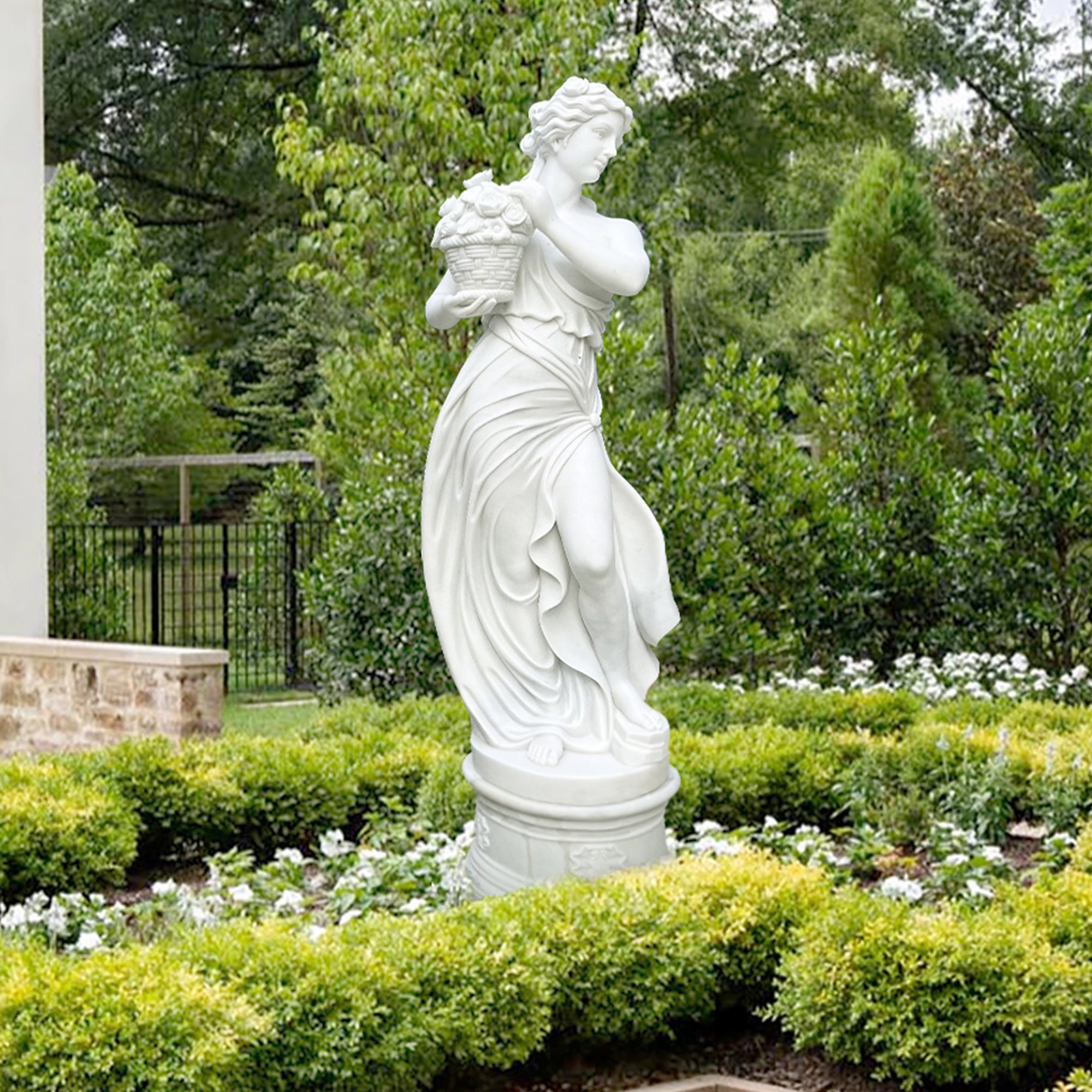 Custom hand-carved white marble Greek Spring Goddess statue from "The Four Seasons" collection, holding a basket of flowers to symbolize renewal and growth, placing in a garden