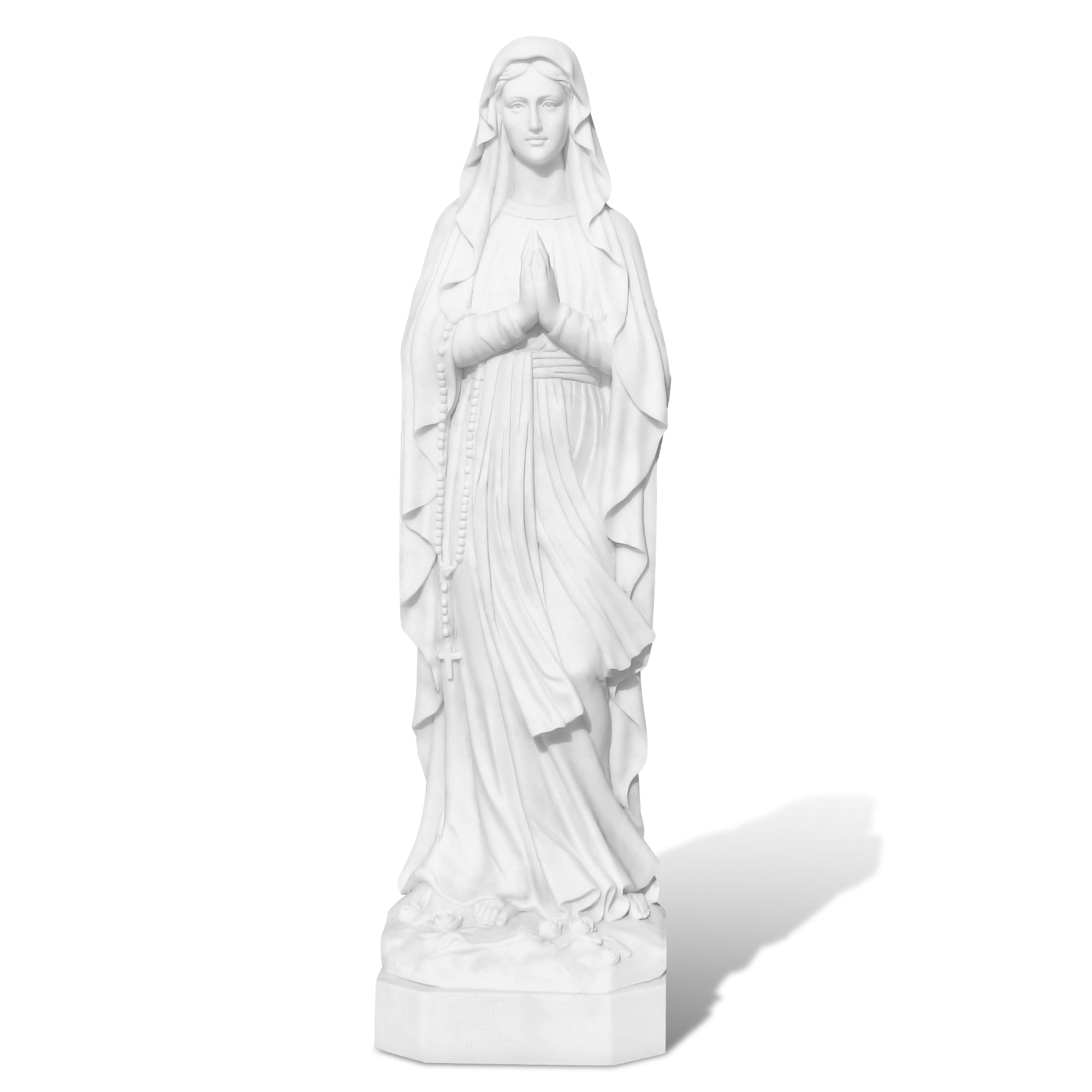 Our Lady of Lourdes statue in prayer pose on white background, carved entirely from natural white marble
