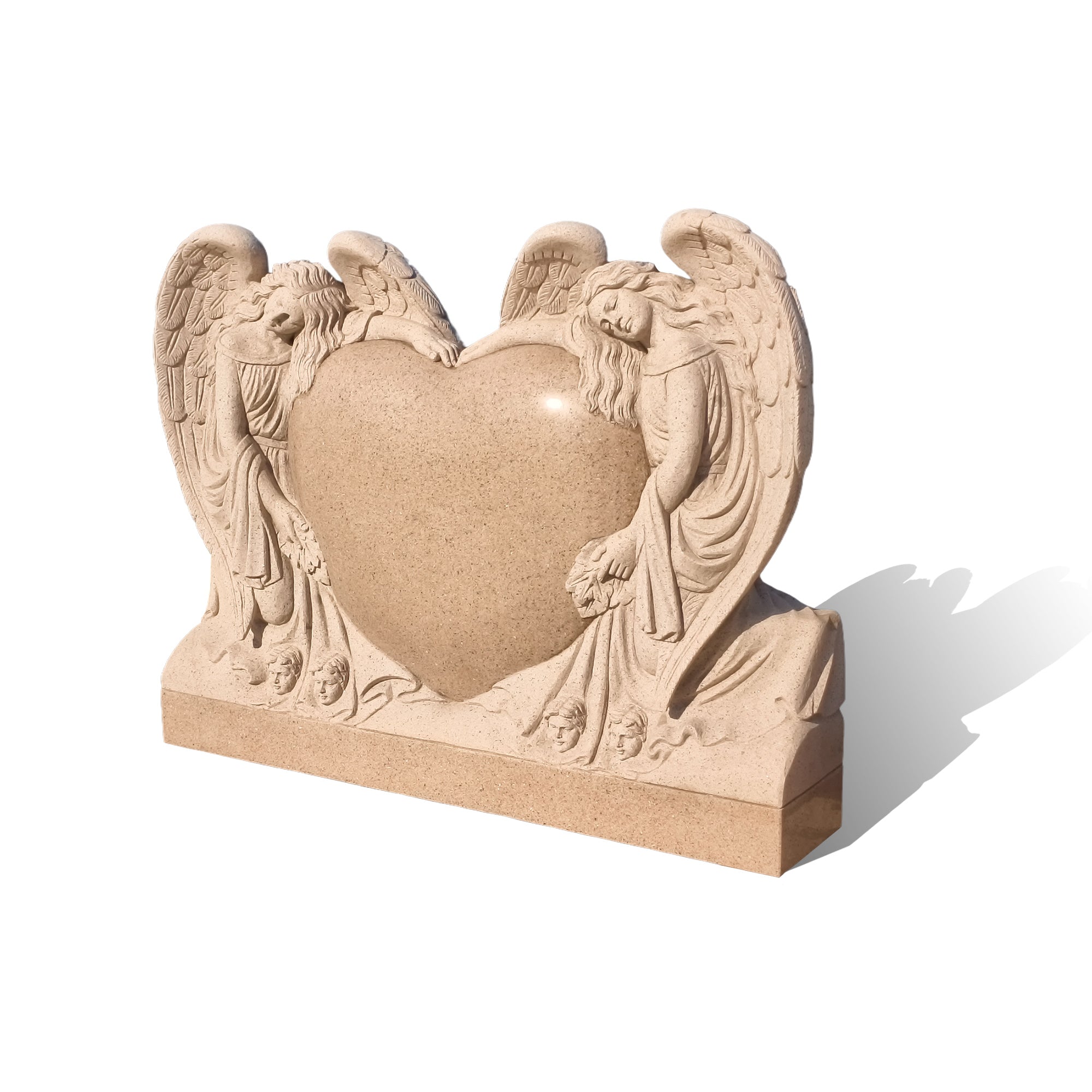 studio shot sesame red granite heart angel headstone with clear view of heart inscription panel and textured wing carving