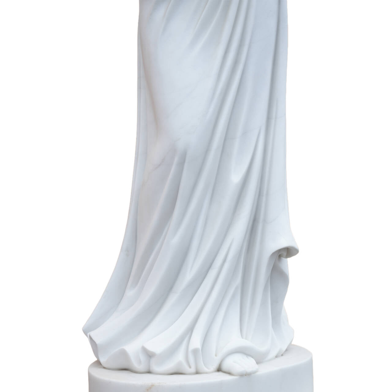 Close-up of a white marble angel sculpture’s flowing drapery and base, highlighting hand-carved folds and elegant stone craftsmanship.