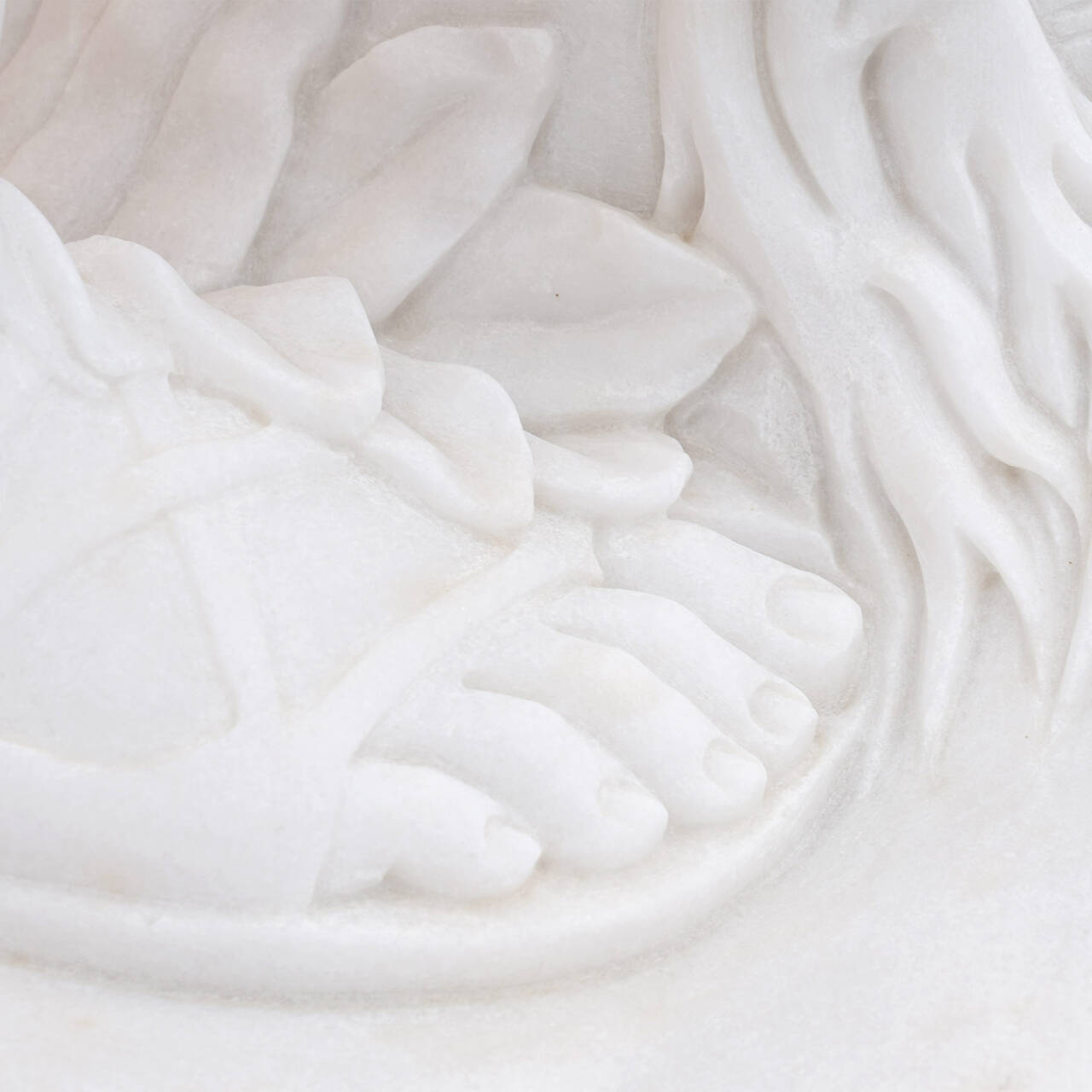 Detail view of Apollo’s marble foot and base in replica Apollo and Daphne sculpture, highlighting precise hand-carved details.