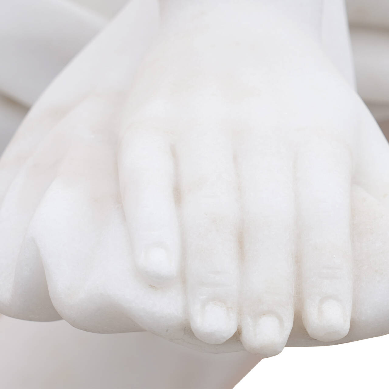 Close-up of hand carving detail in replica Apollo and Daphne marble statue, showing delicate fingers and refined classical sculpting