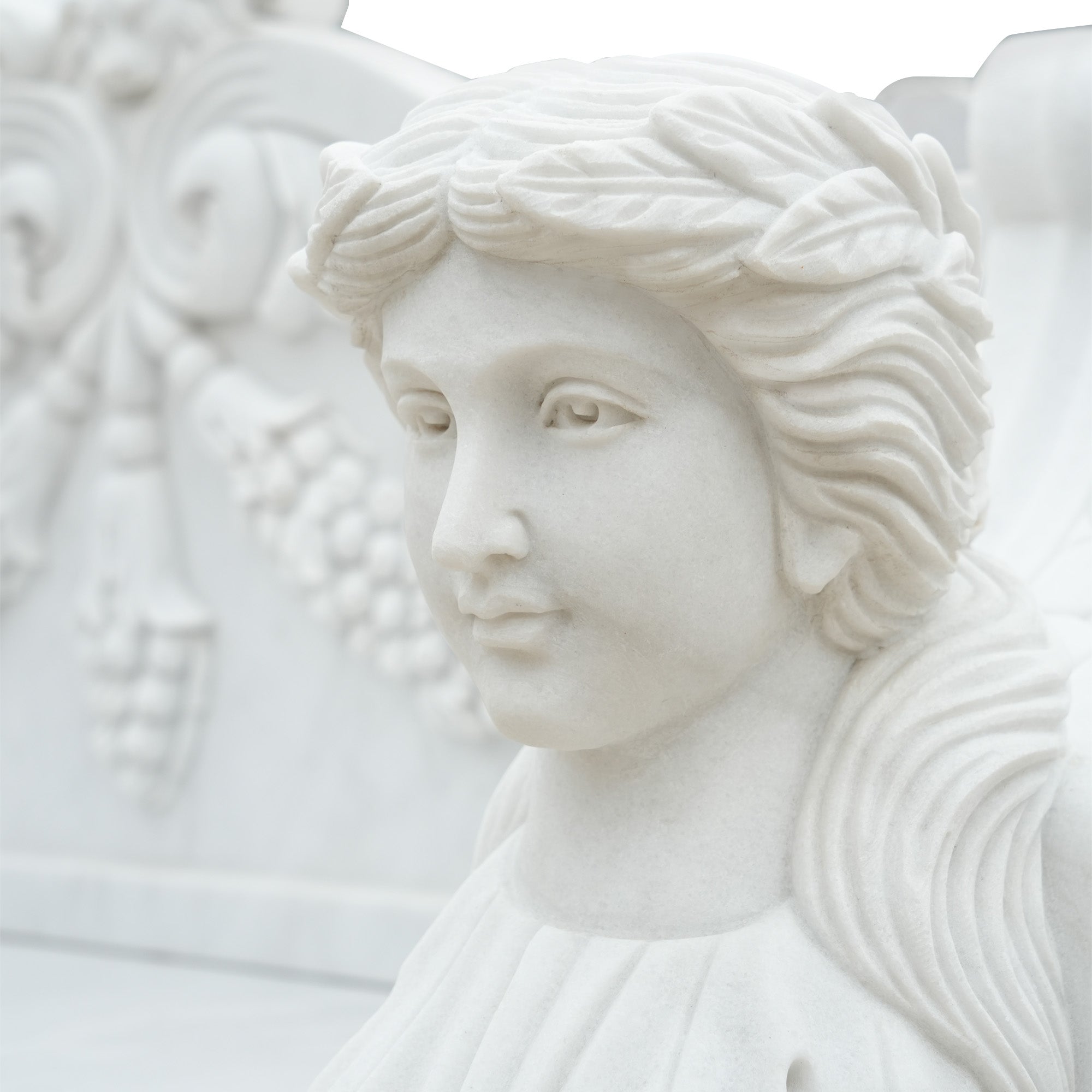 Close-up of the female head sculpture on a marble garden bench, showcasing detailed carving and serene expression, ideal for classical outdoor settings.