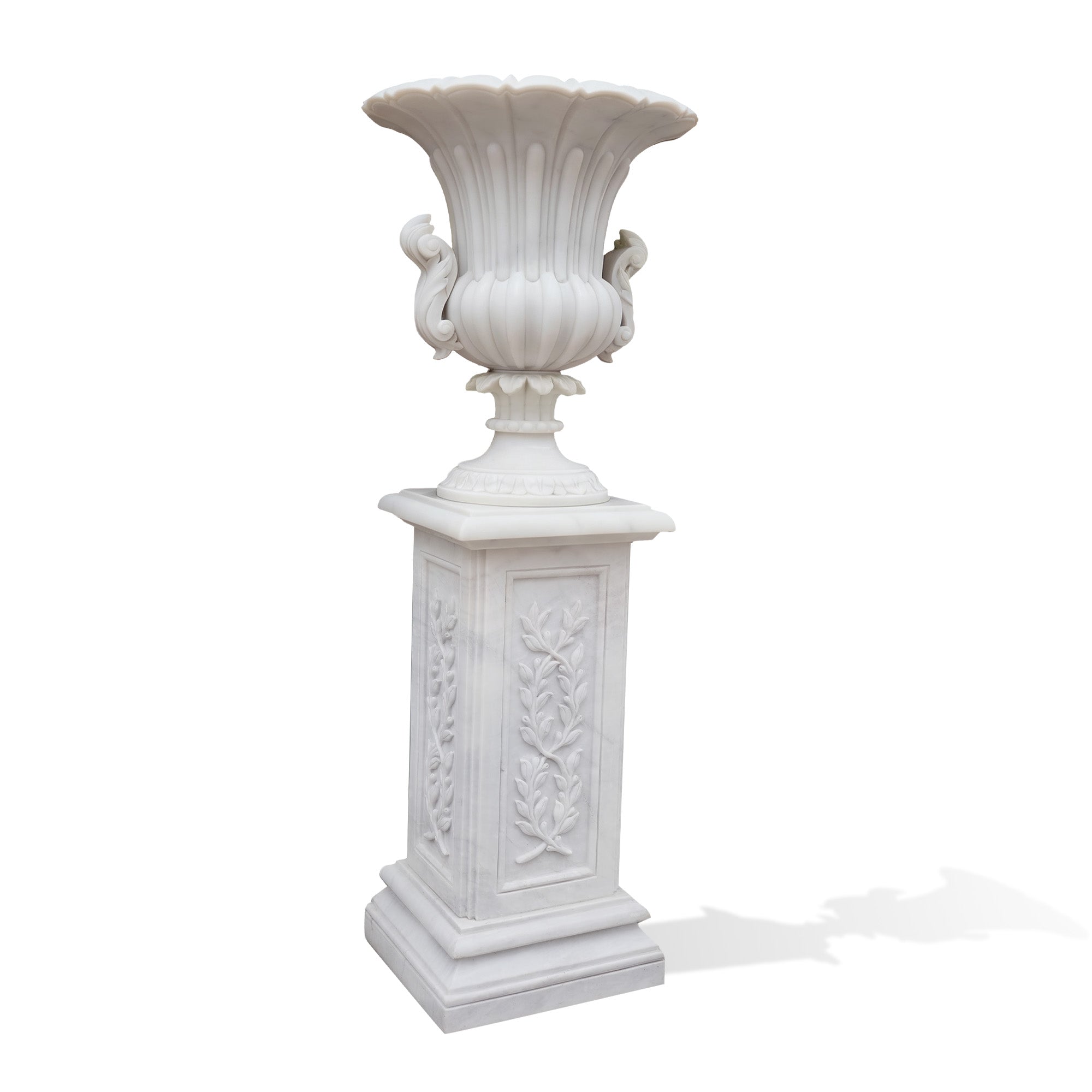 Ornate marble garden vase with intricate floral carvings and pedestal stand, perfect for showcasing flowers in upscale garden spaces.