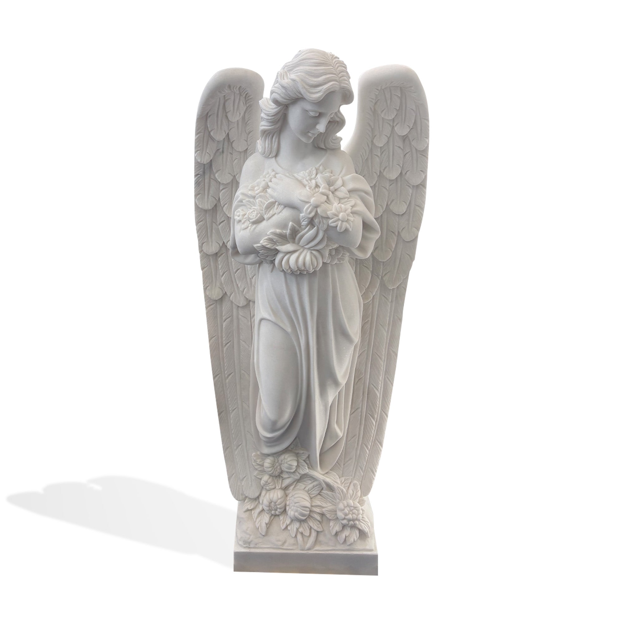 White marble angel memorial statue front view, standing guardian angel sculpture with folded arms, flower bouquet, and detailed wings for cemetery headstone decoration