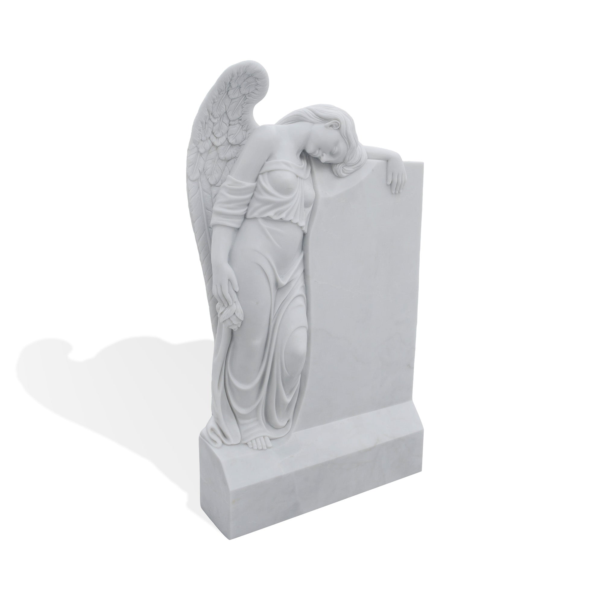 Side view of a white marble angel gravestone memorial sculpture with carved wings and upright headstone