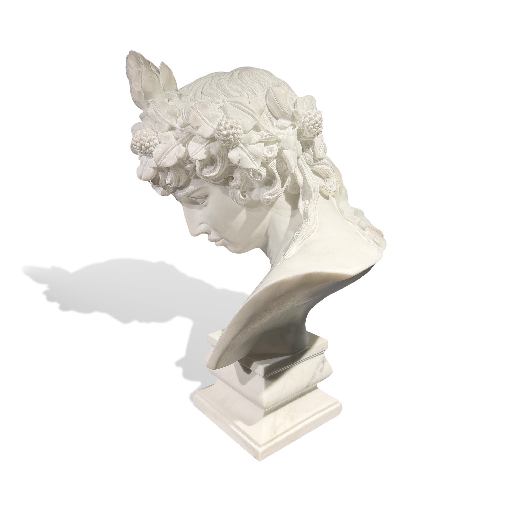 side profile of classical marble male bust sculpture featuring detailed leaf crown and flowing carved hair inspired by Greco Roman art