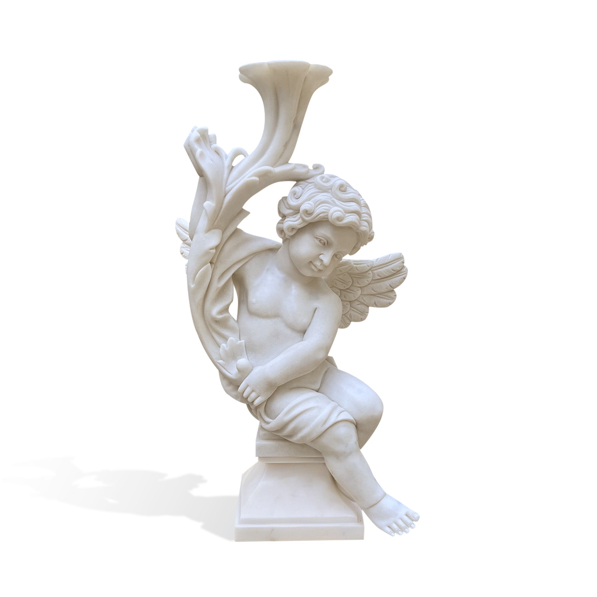 Hand carved white marble seated cherub angel statue holding a decorative floral horn with detailed wings and a pedestal base