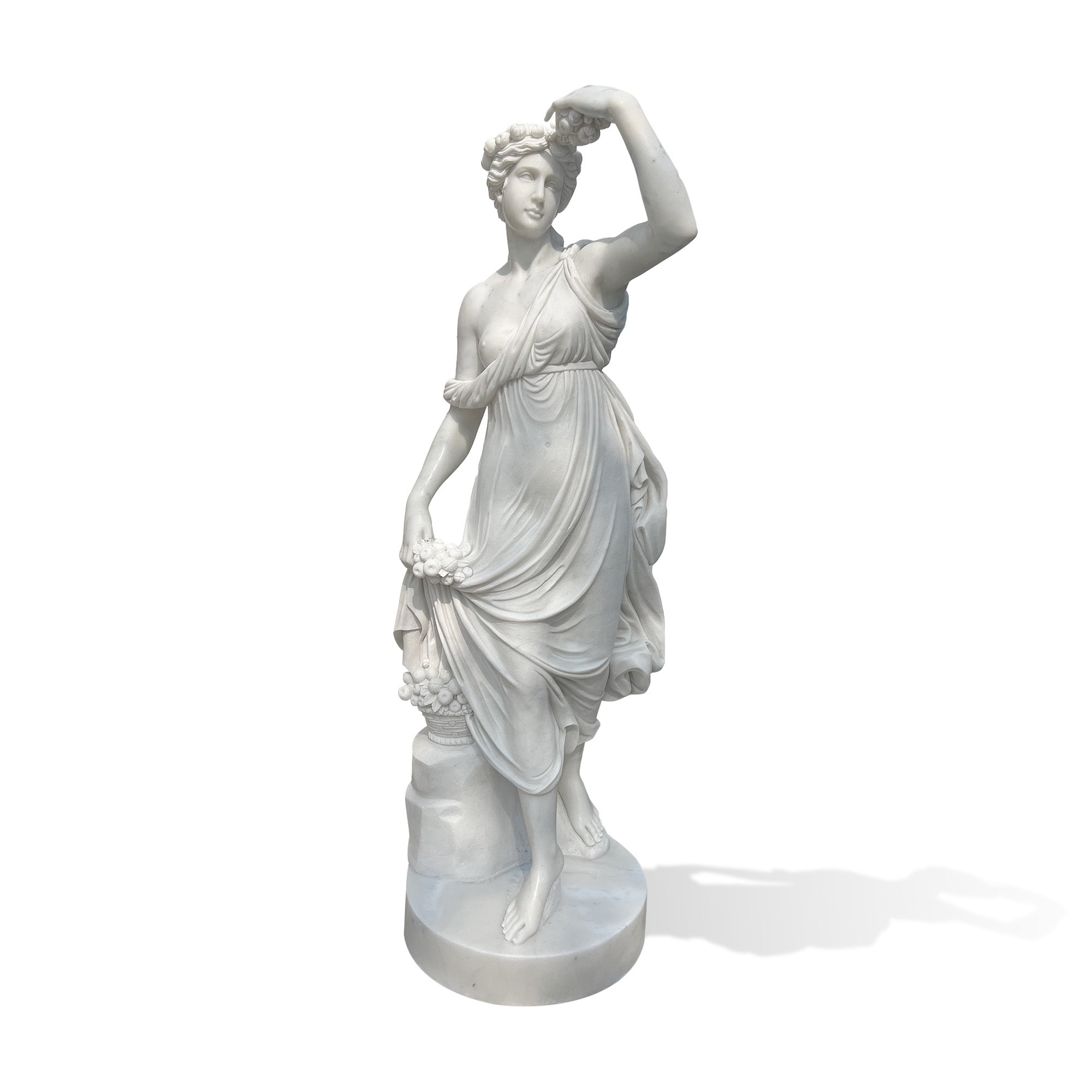 Front view of a hand-carved white marble Flora goddess garden statue holding flowers on a round base