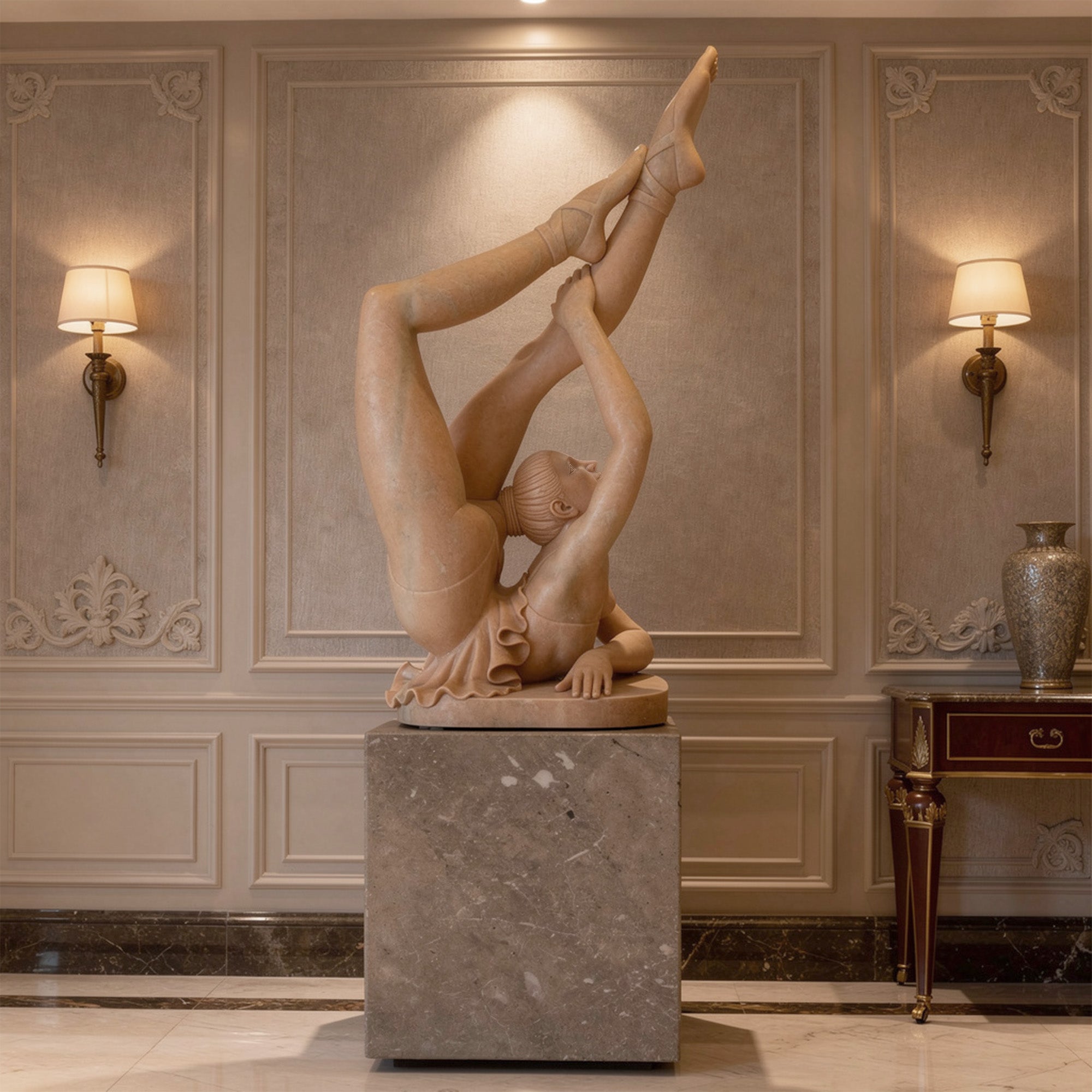 Red marble ballet dancer statue presented on a stone pedestal in a luxury interior with warm lighting, decorative wall panels, and an elegant gallery-style setting