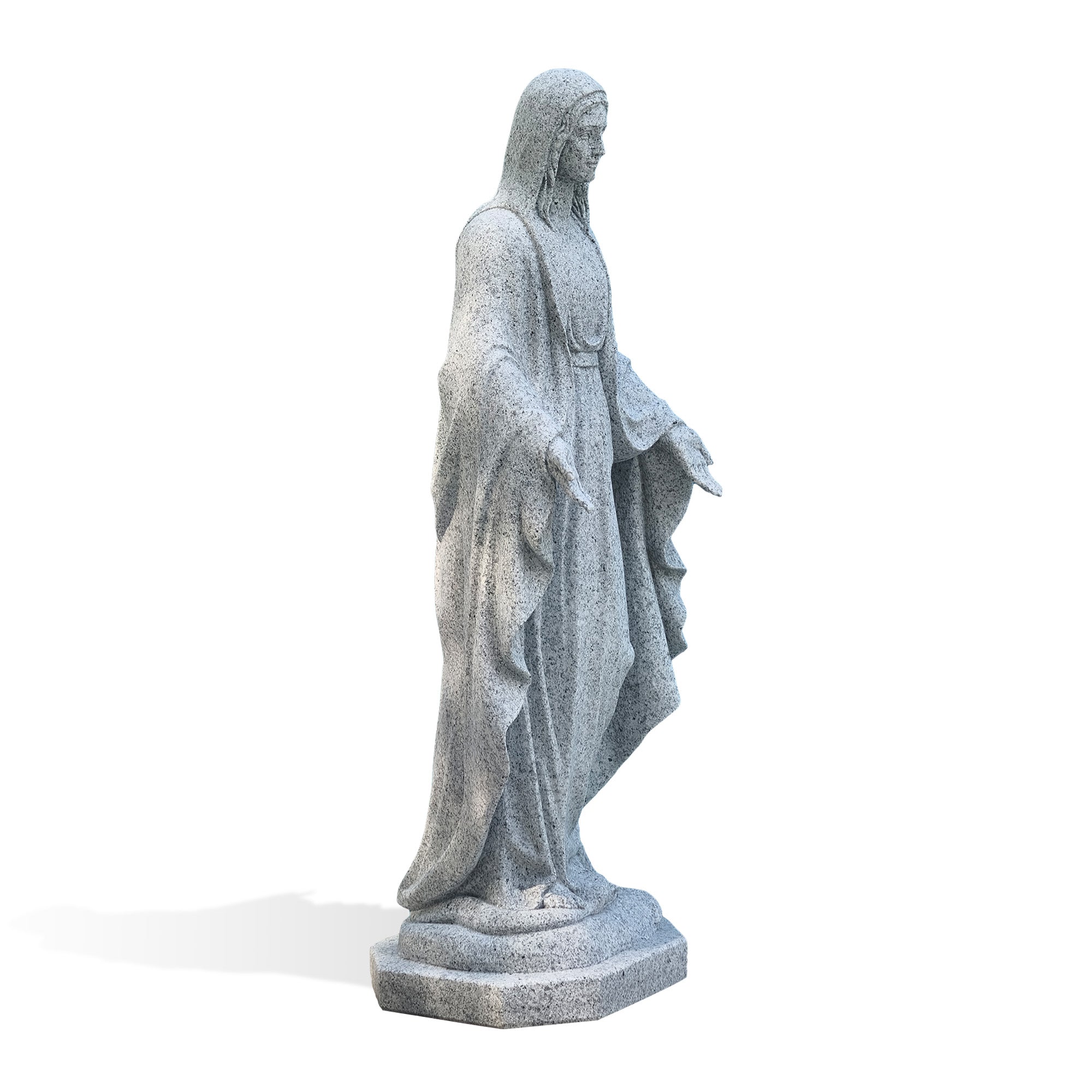 Side profile of a natural grey granite Mary statue with extended hands, layered garment folds, and a carved pedestal base