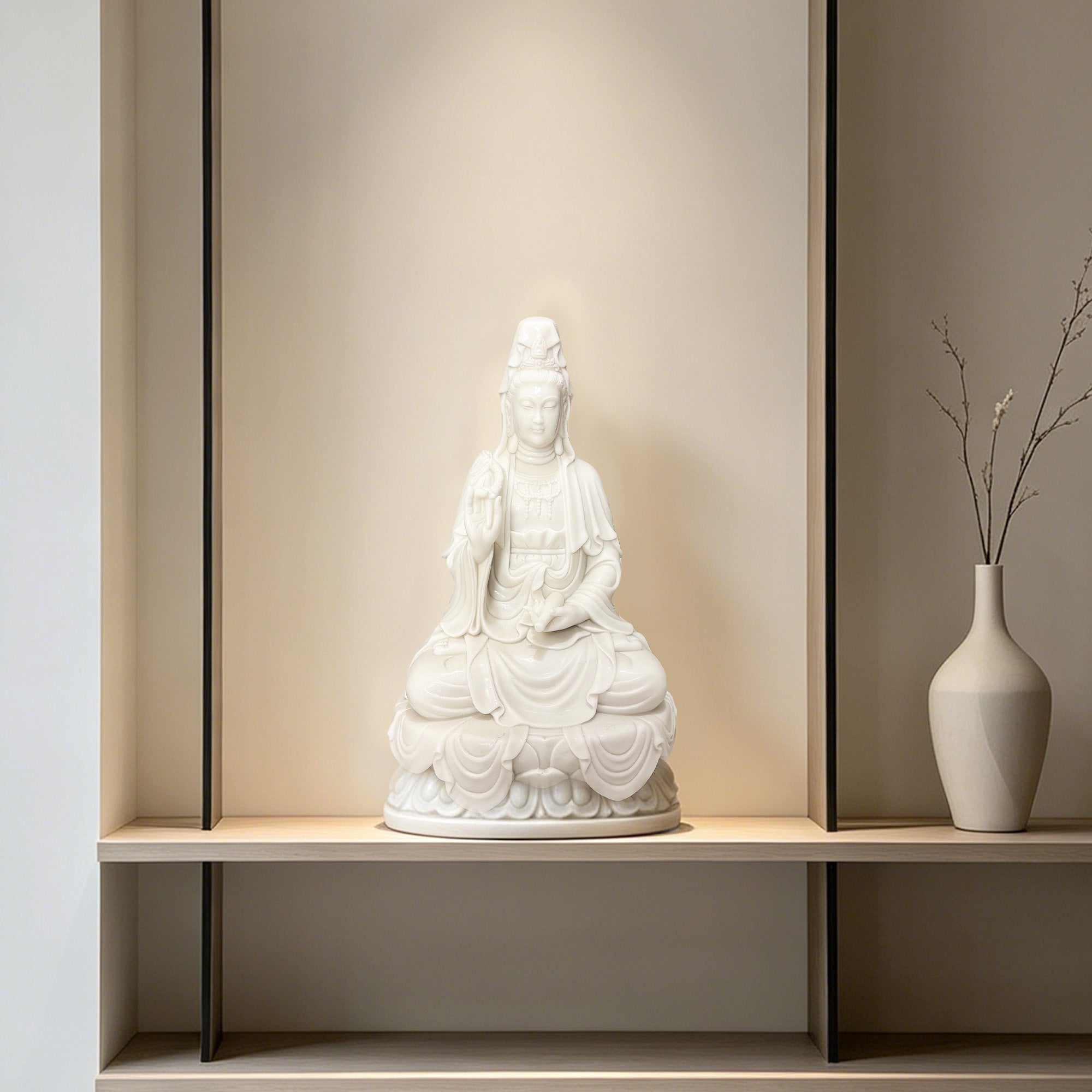 White marble seated Guanyin statue displayed in a softly lit interior niche as peaceful meditation room and wellness decor