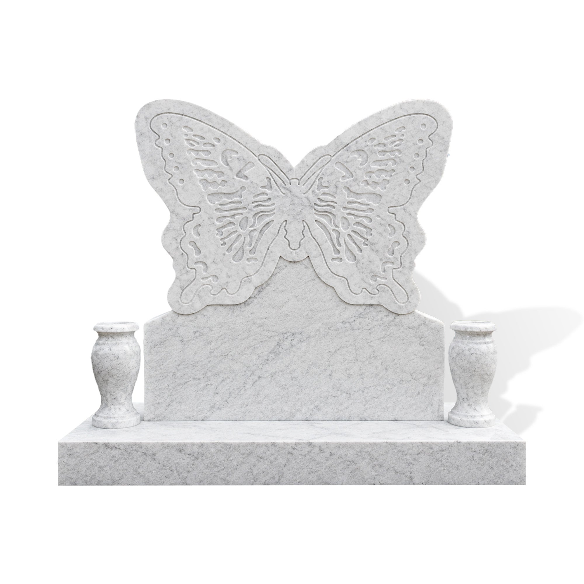 Carrara white marble butterfly memorial monument displayed in a landscaped cemetery garden, featuring carved wing patterns, a white marble tablet, twin vases, and a bright natural stone finish.