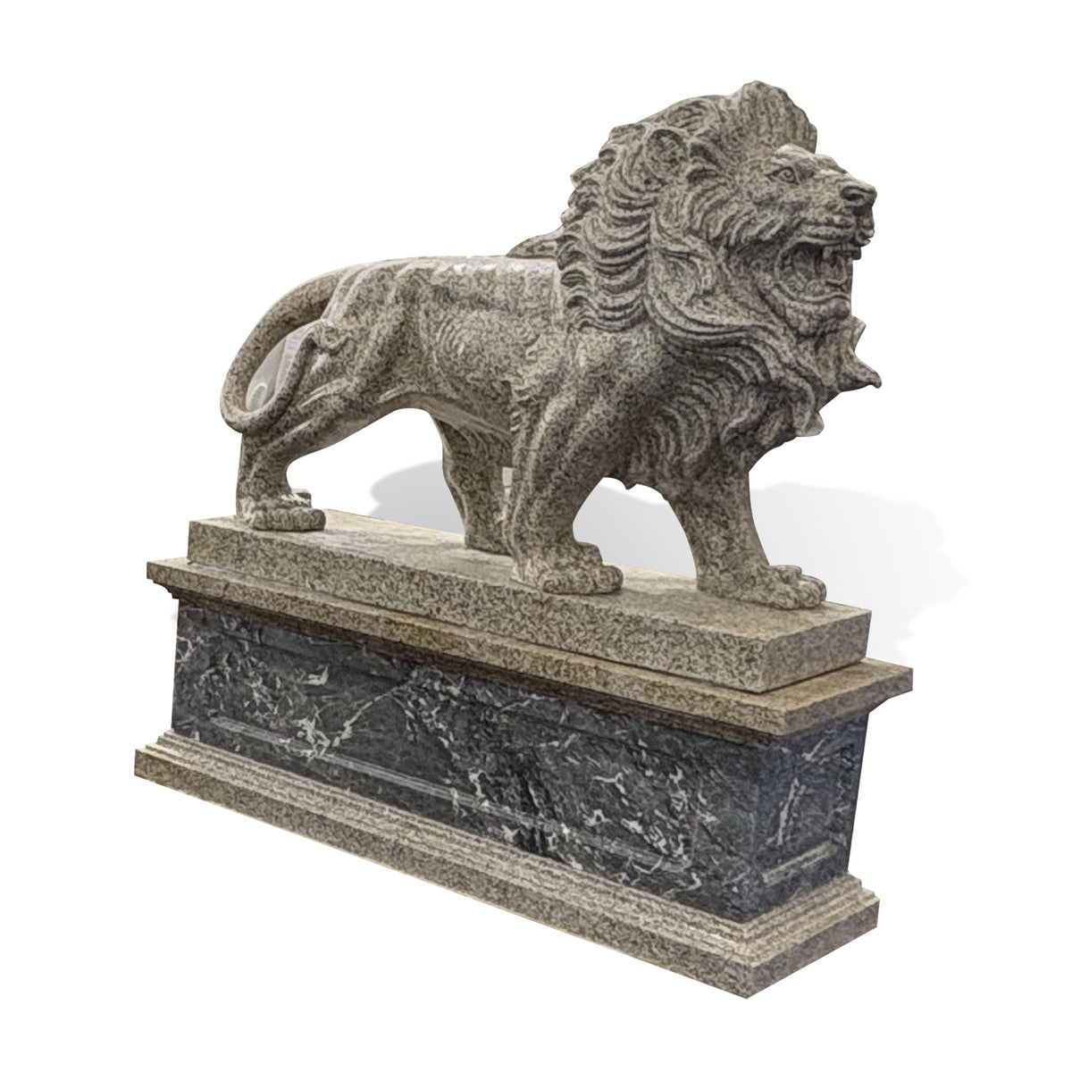 Side view of a roaring stone lion sculpture featuring an open mouth, muscular body, carved mane and curled tail on a stone base.
