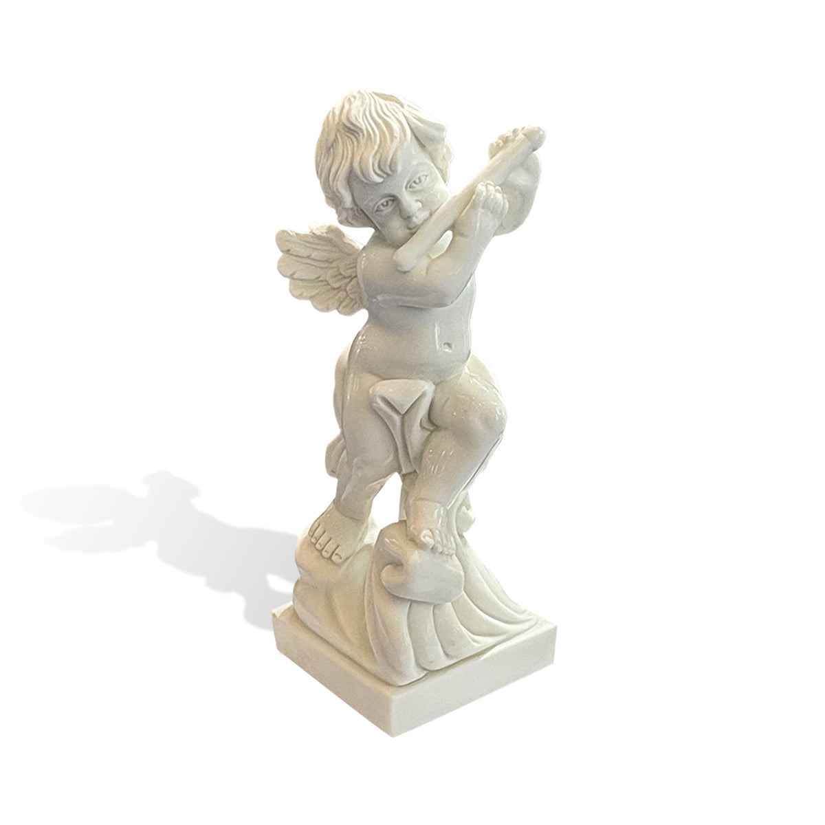 Hand-carved white marble cherub statue holding a flute-like wind instrument, with curled hair, feathered wings and an ornamental scrollwork base.