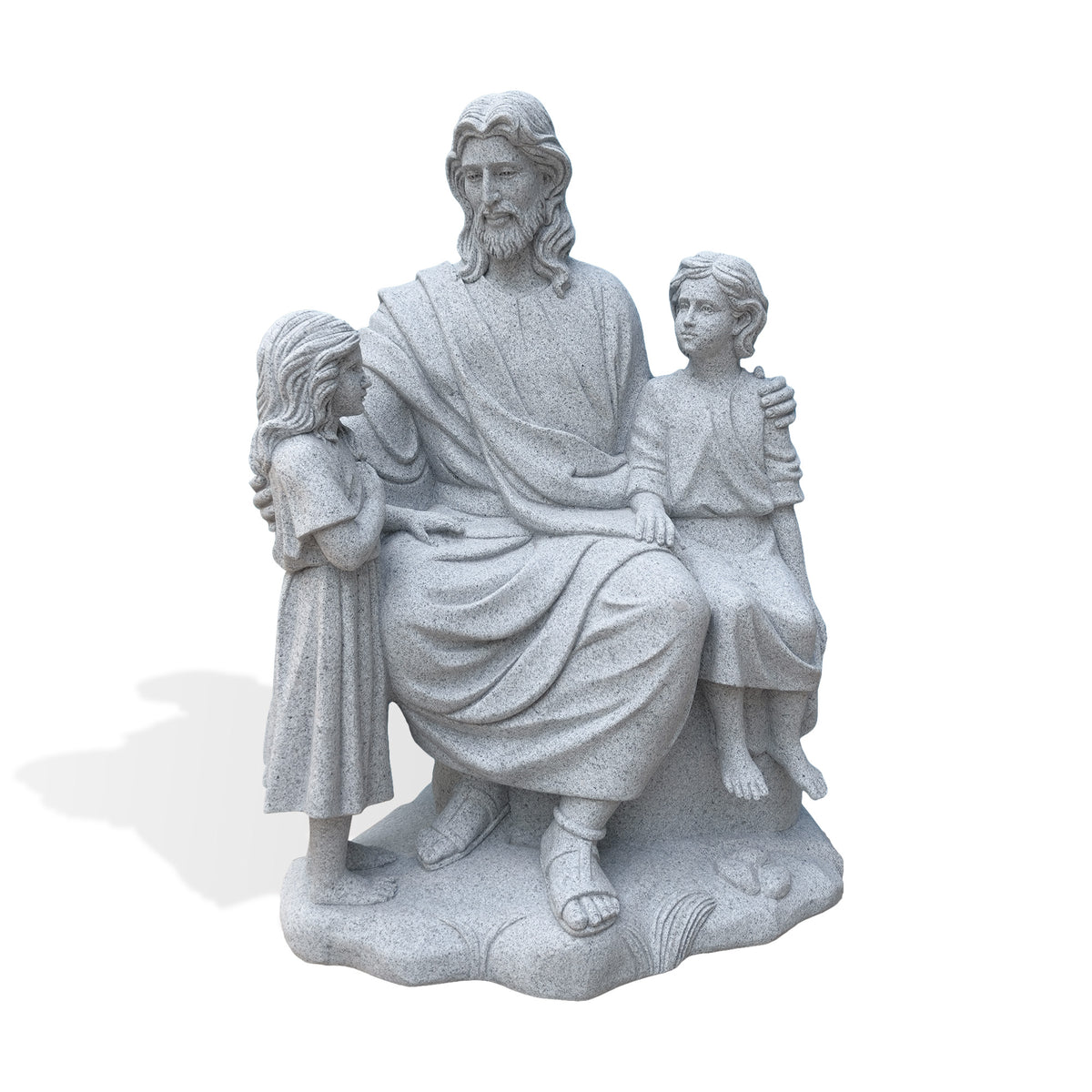 Front view of a granite statue depicting a seated Jesus with long wavy hair, a beard and draped robes, embracing two children. A girl stands with one hand near her chest while a barefoot boy sits beside him, all supported by a textured stone base against a white background.