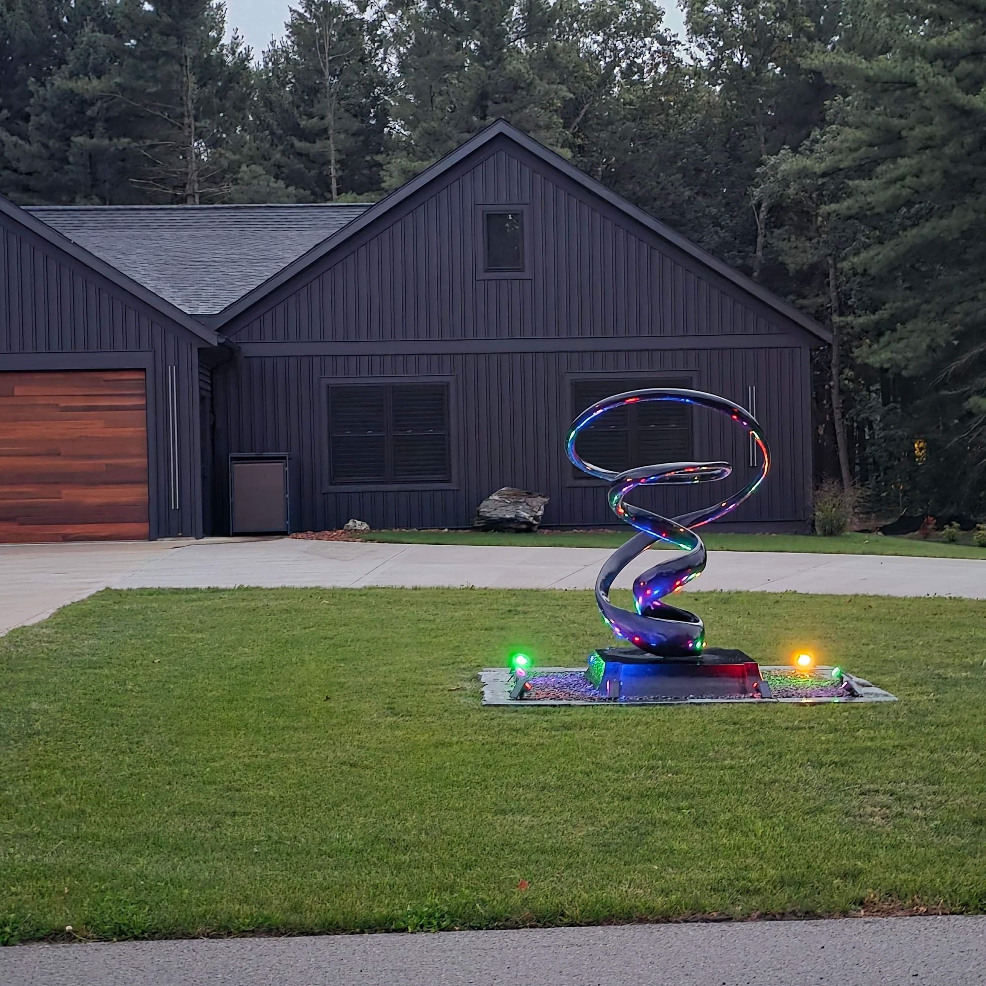 large abstract outdoor metal sculpture in residential front yard during daytime savannah way muskegon michigan