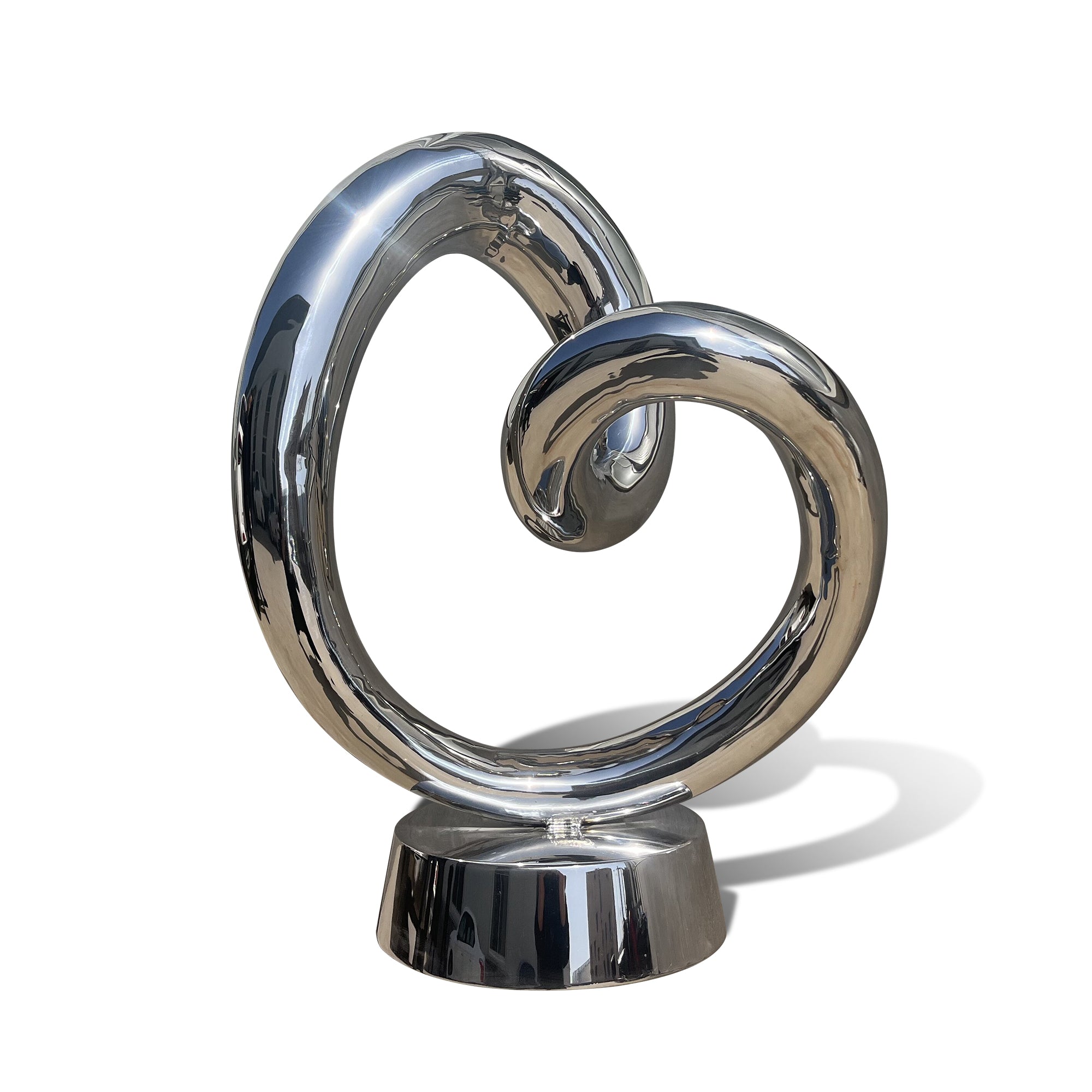 mirror finish stainless steel heart sculpture with a swirling design on a white background
