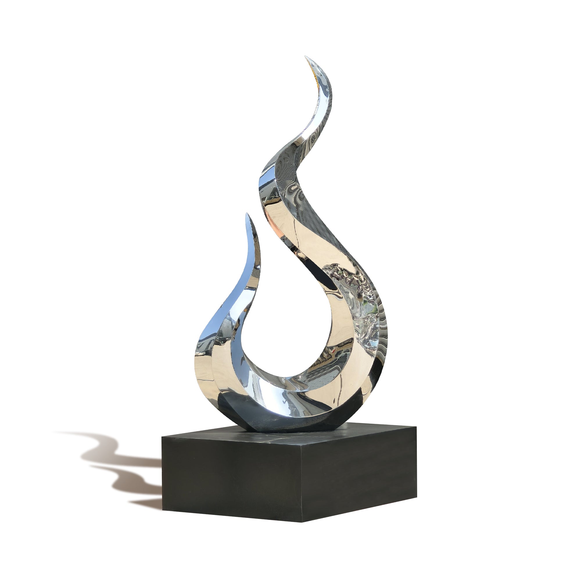 Abstract metal sculpture on a black base against a white background