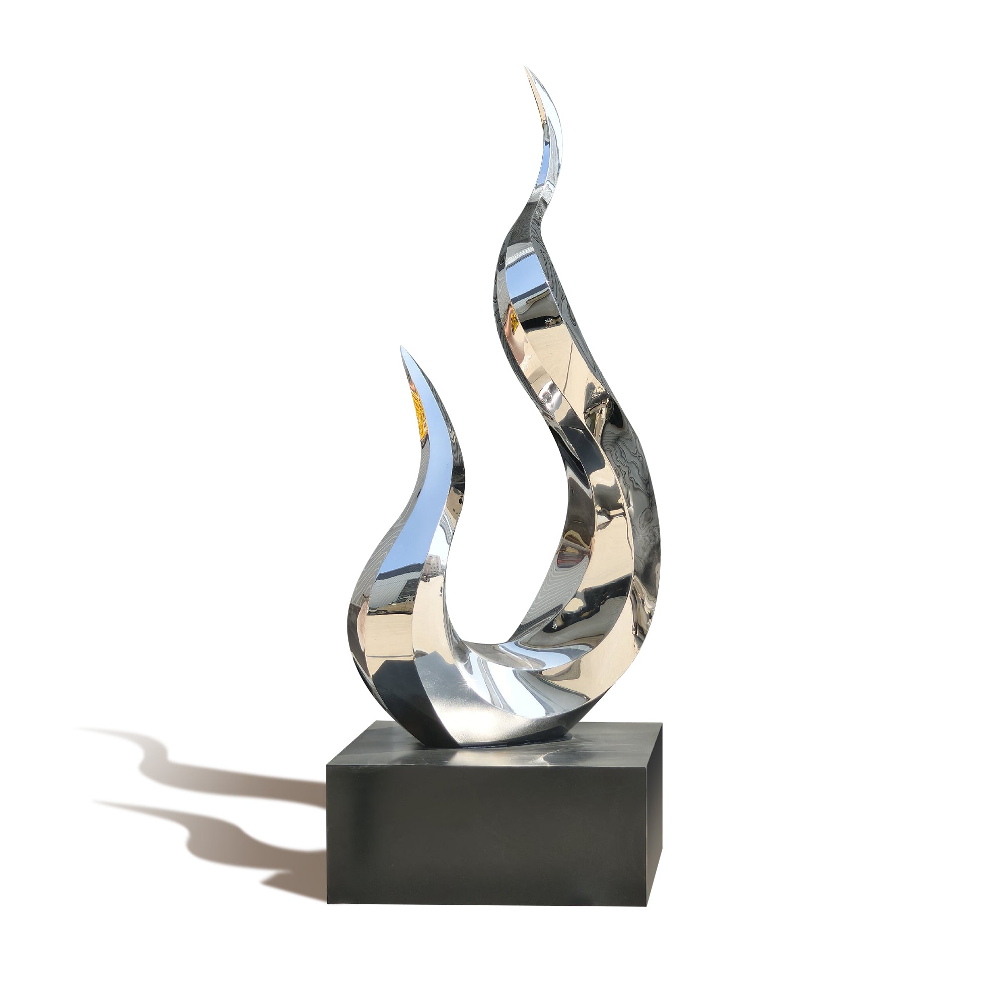 Abstract metal sculpture on a black base against a white background