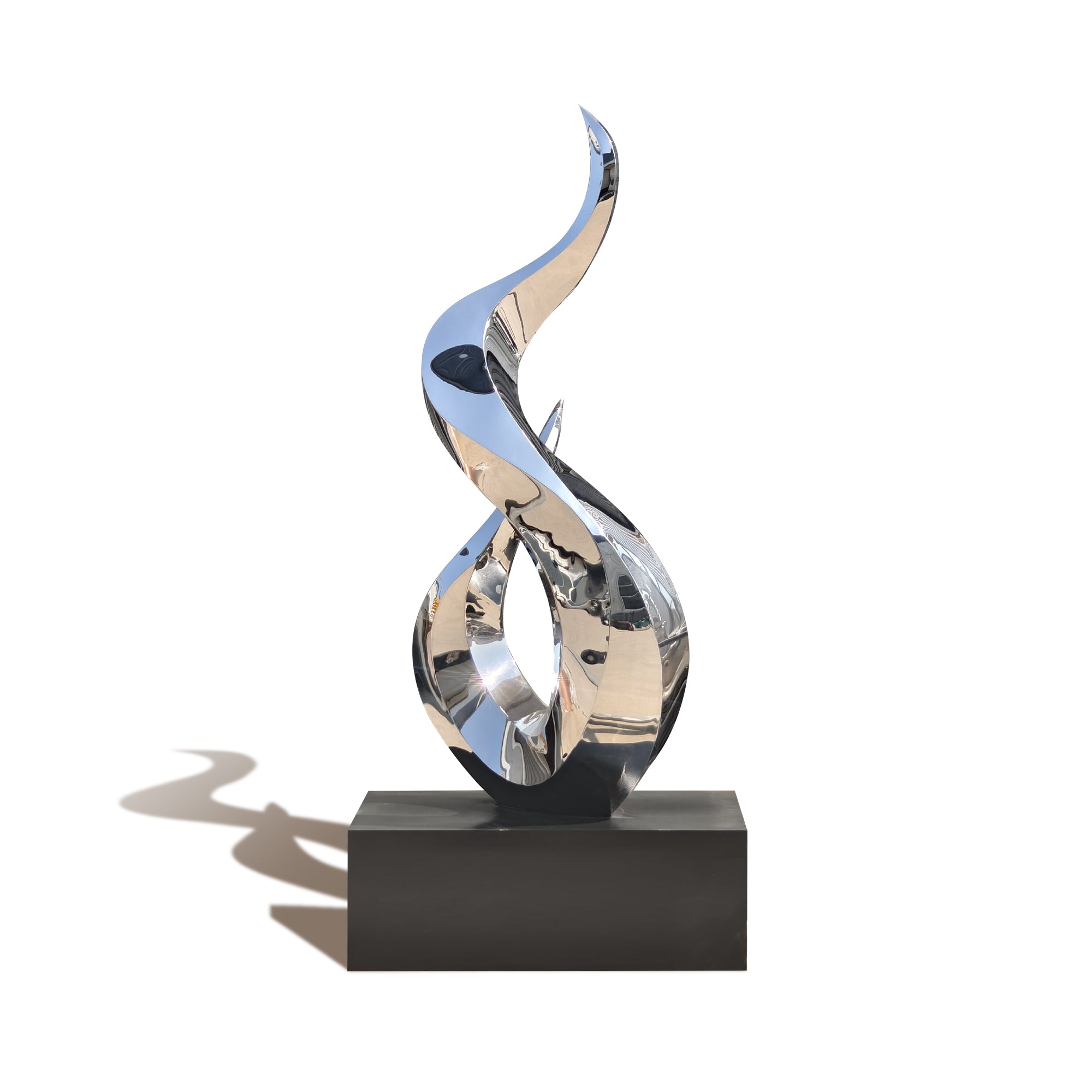 Abstract metal sculpture on a black base against a white background