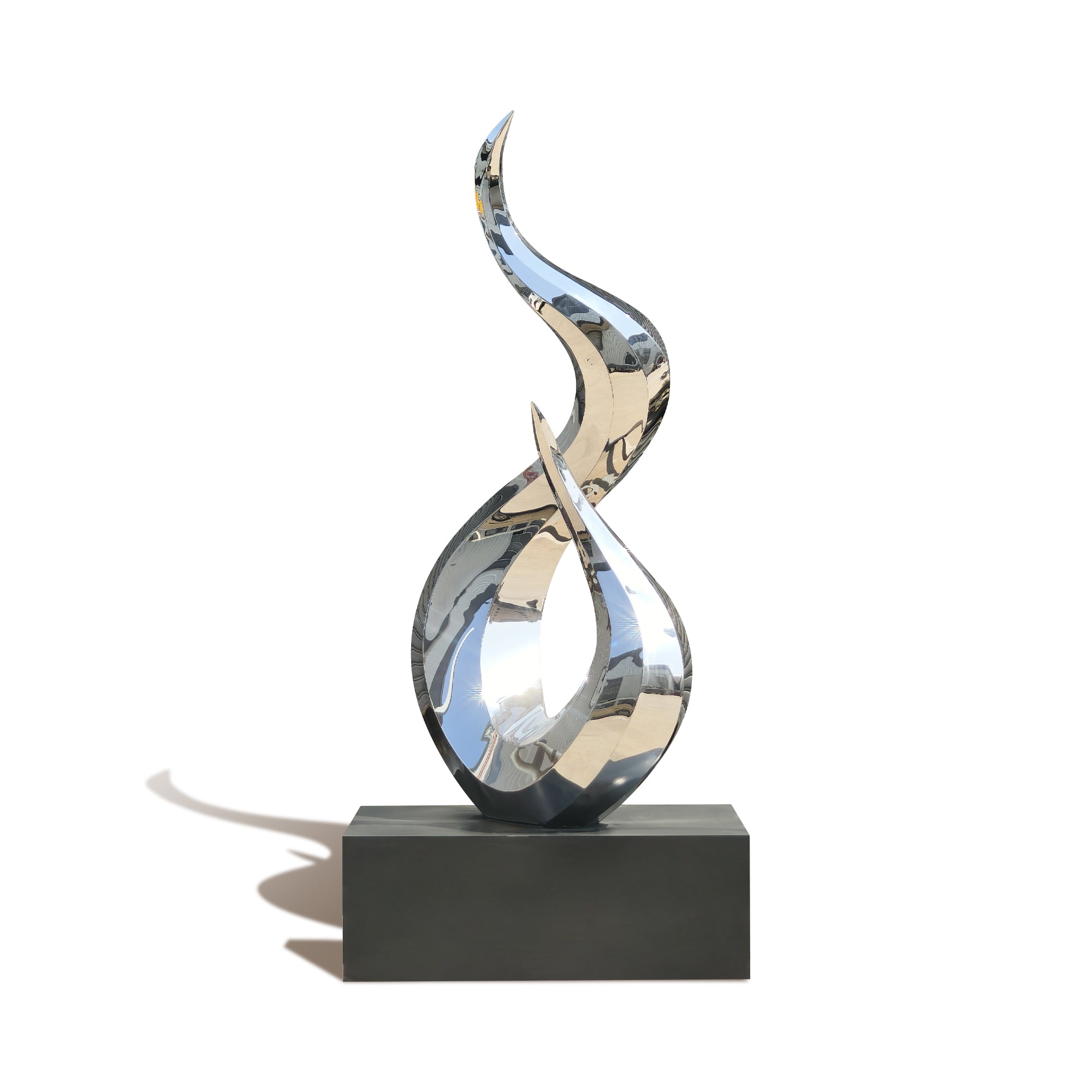 Abstract silver sculpture on a black base against a white background